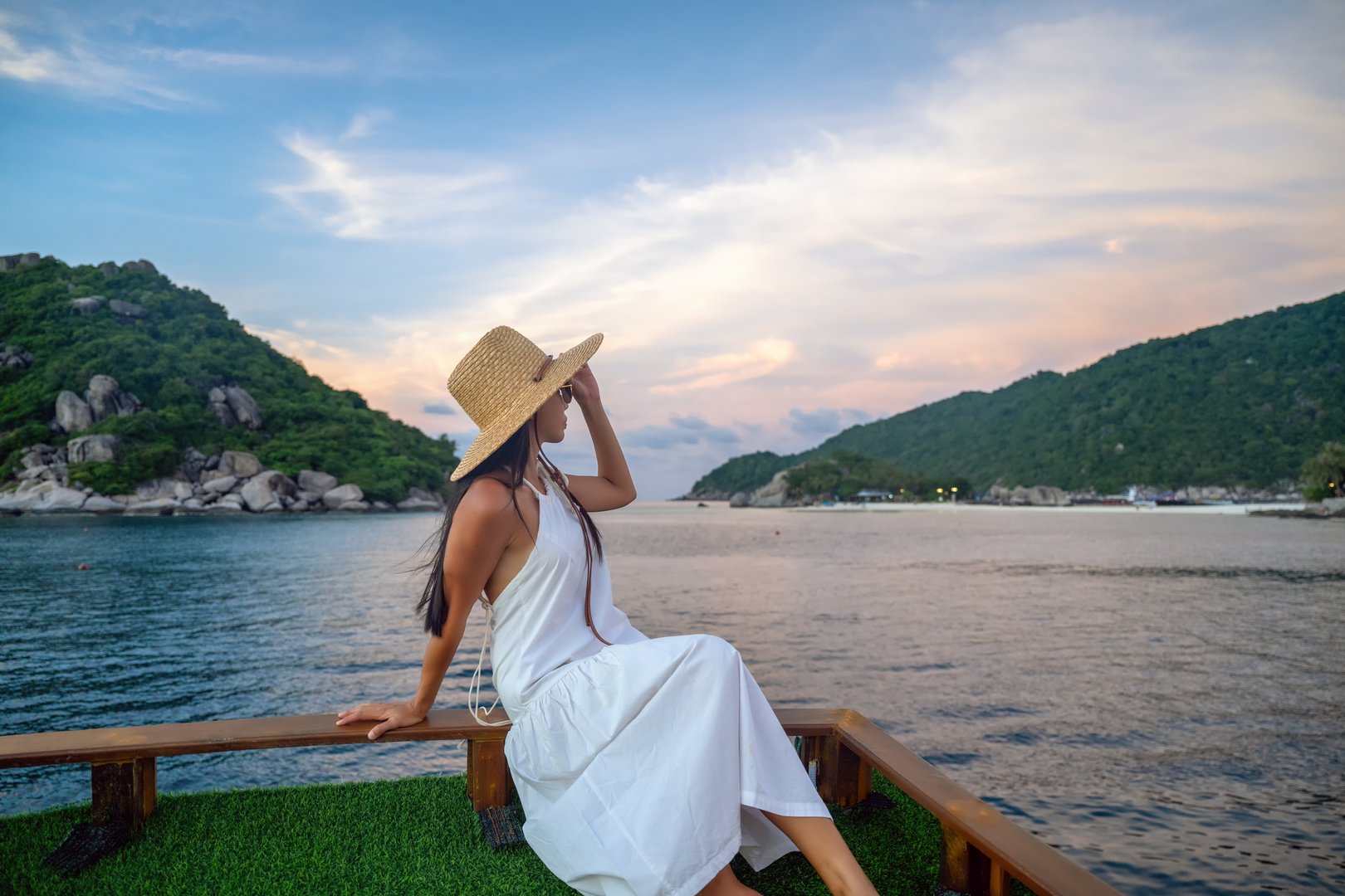 woman in dress stay on deck of the charter boat yacht sailing route to the island sunset sightseeing