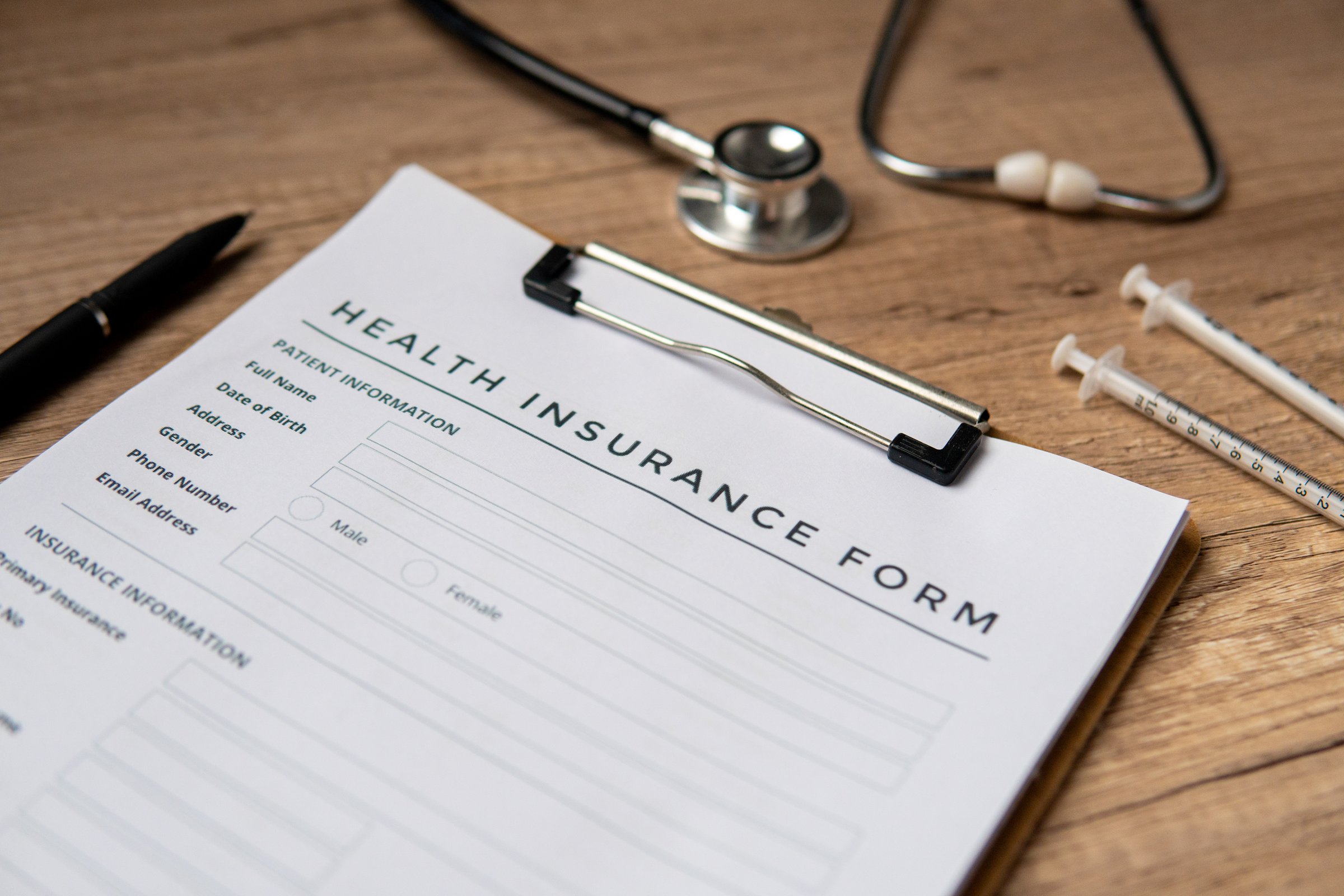 A close-up image of health insurance form on a clipboard. Medical and insurance concept.