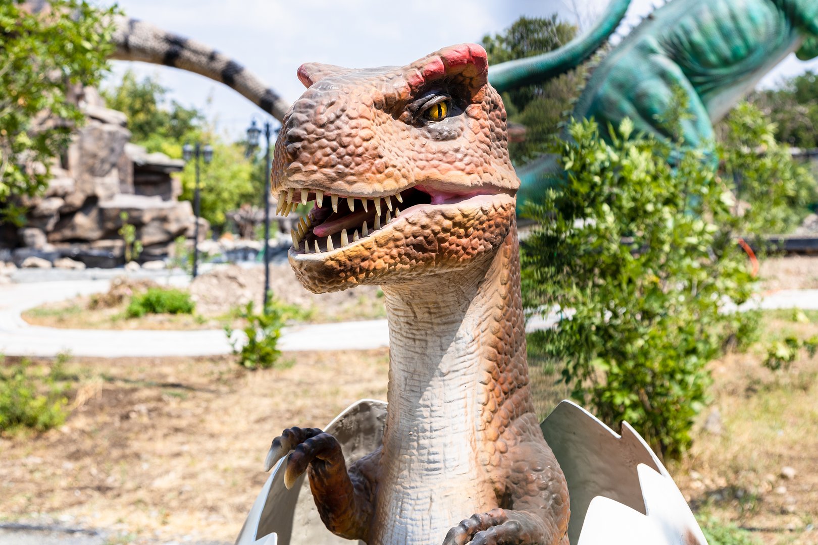Yerevan, Armenia - August 11, 2024: dinosaur figure on site of Jurassic Park in Victory park in Yerevan city on sunny summer day