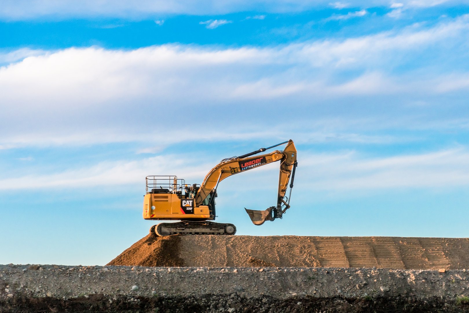 Singleton Australia 2022-04-21 Cat yellow heavy machinery excavator digger on a road construction site.