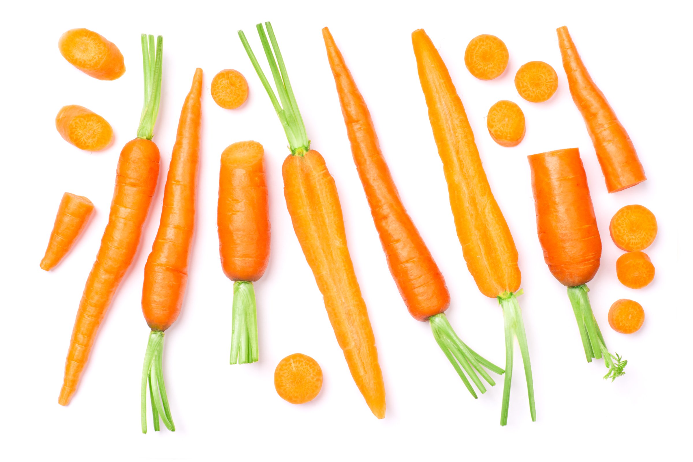 Set of baby carrots and carrot cut sliced isolated on white background. Top view, flat lay.