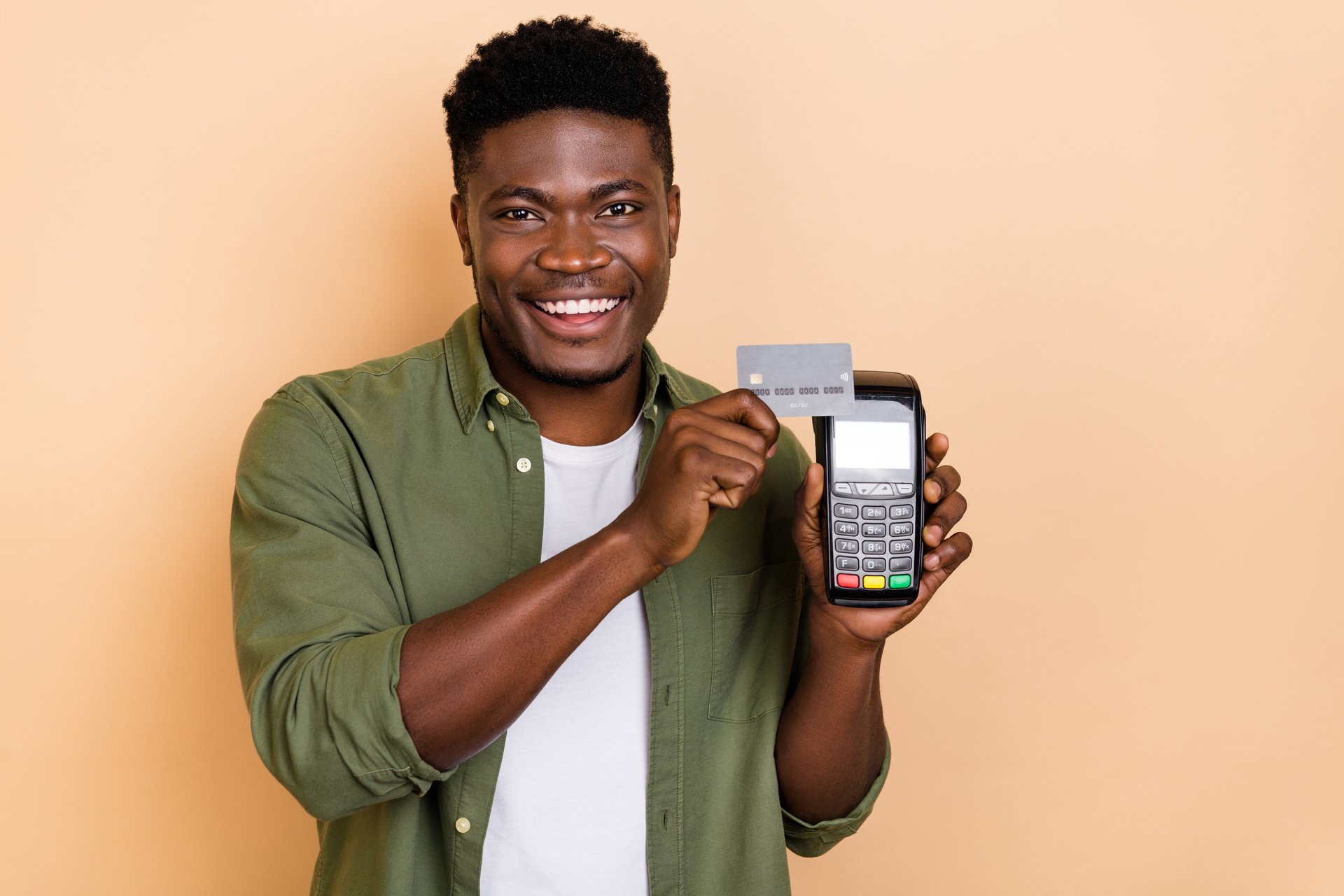 Photo of positive guy buyer swipe credit card paying purchase atm service isolated on pastel color background.