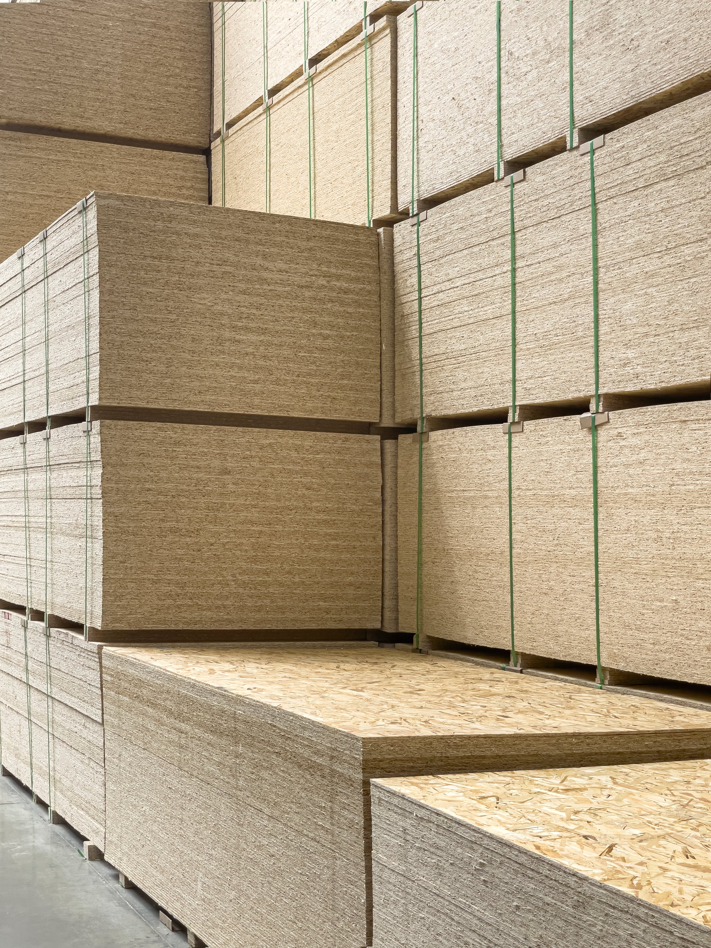 Sheet stack in a construction store. Engineered wood product for load-bearing applications in construction. OSB - Oriented Strand Board.