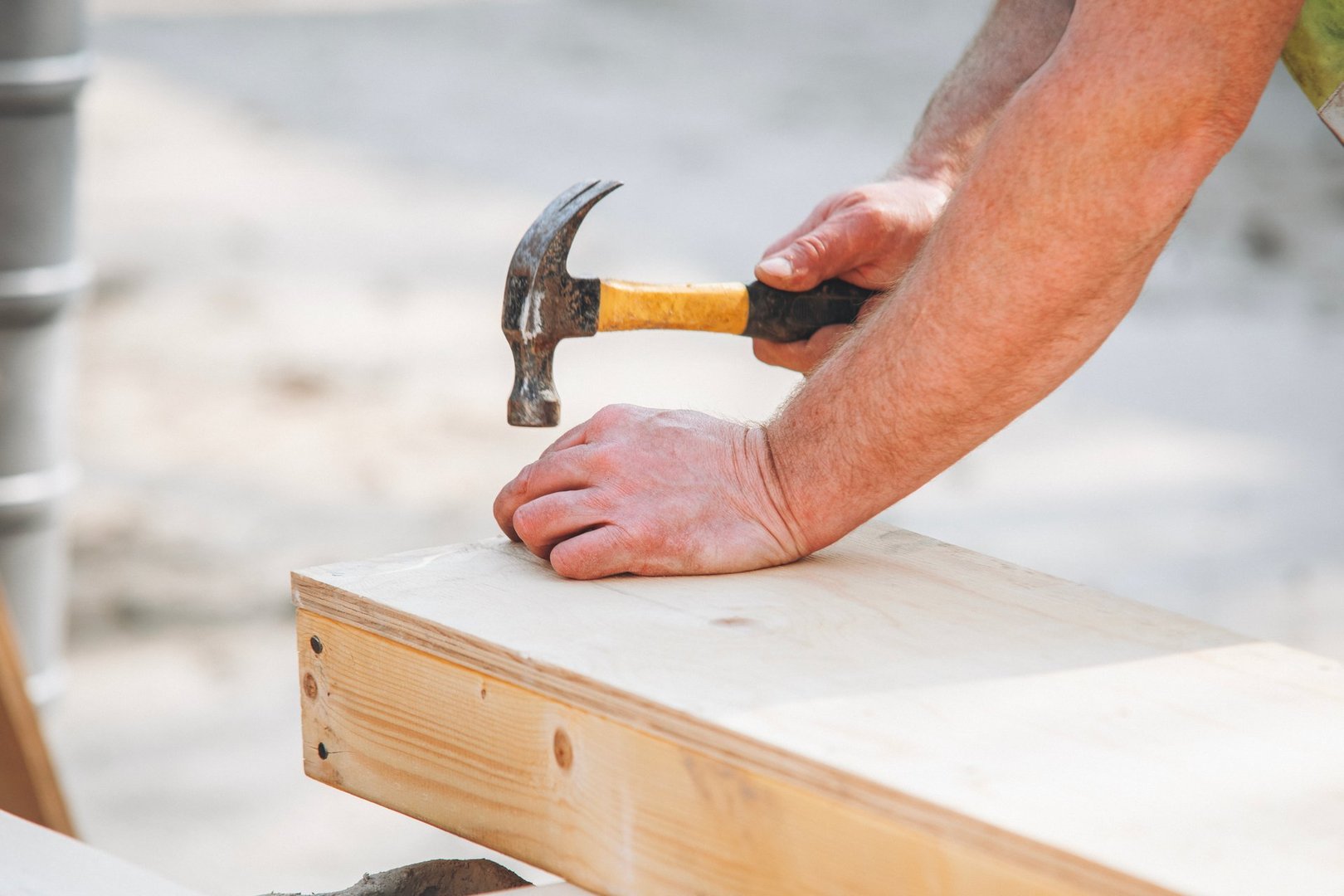 Close-up of hands of Craftsman joiner working on wood and plywood shutter construction