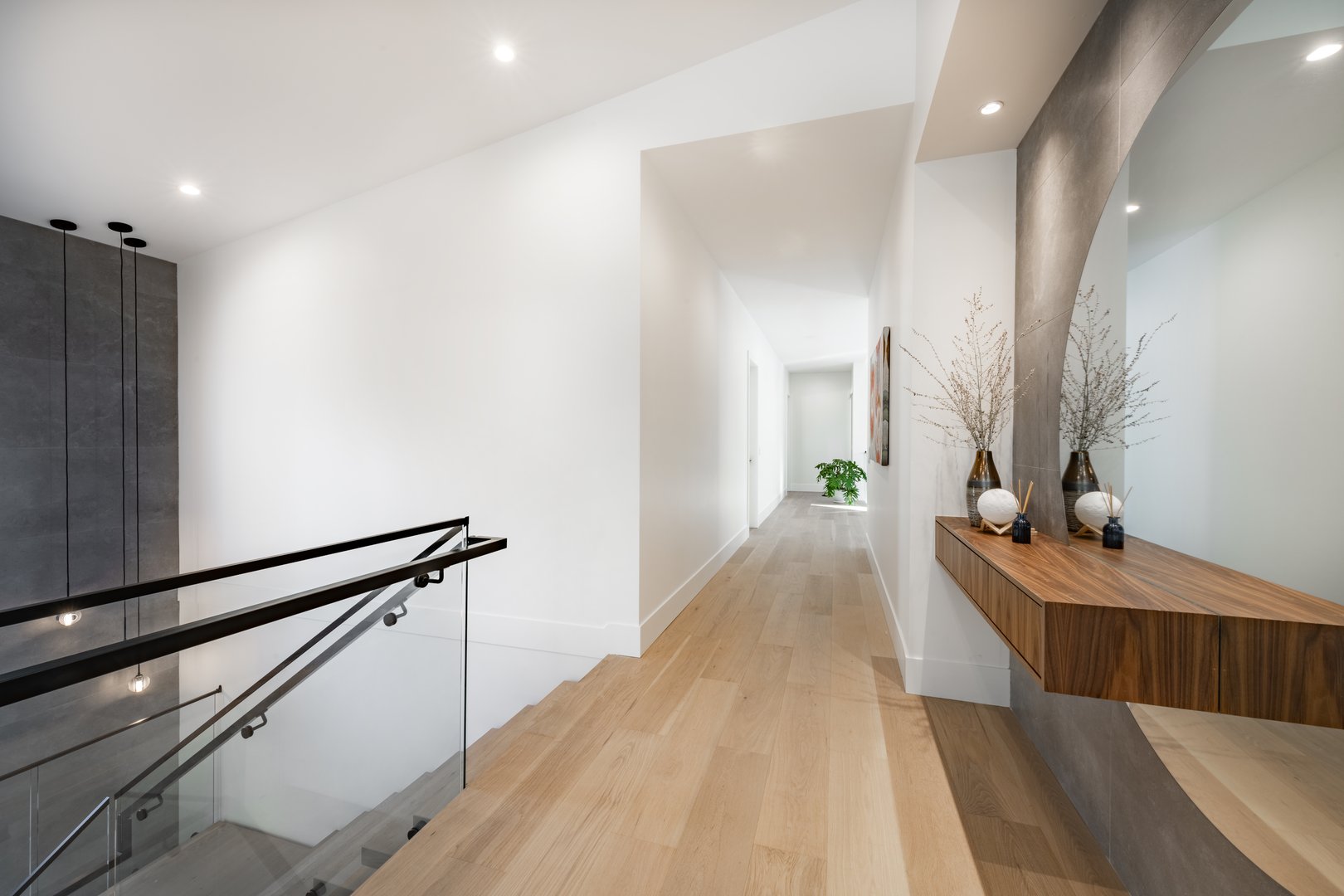 A very large modern contemporary private residence residential home spacious interiors living room, kitchen, office, recreation room, foyer, hallway, floating staircase window wall open to a patio with BBQ and swimming pool. New construction family home