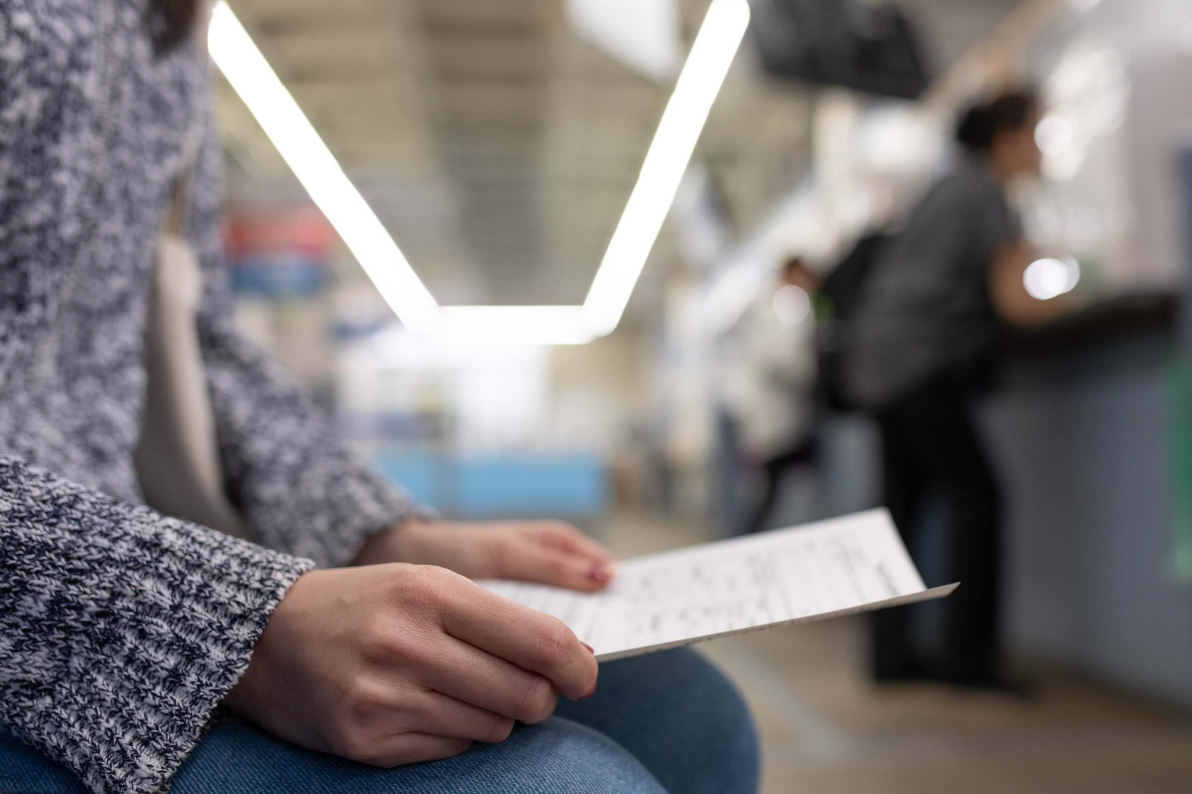 Woman's hand holding an application form