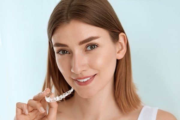 Woman with perfect straight teeth after orthodontic treatment with braces and clear aligners at Dentists@Labrador