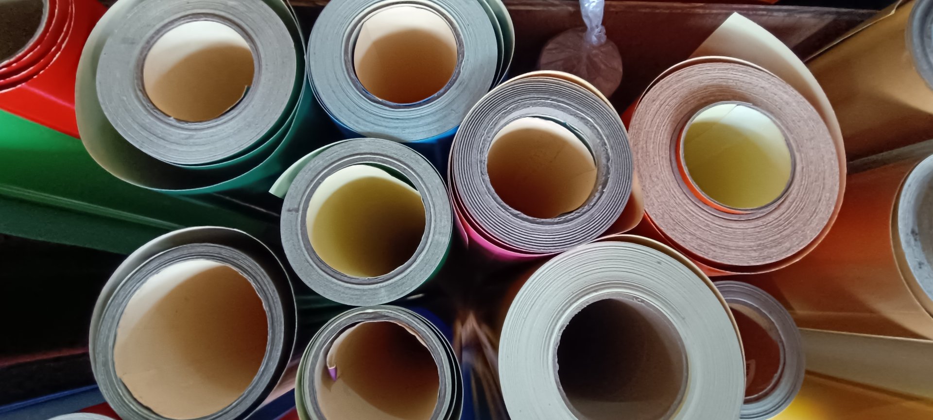 Top view of stock rolls of vinyl stickers in a shop