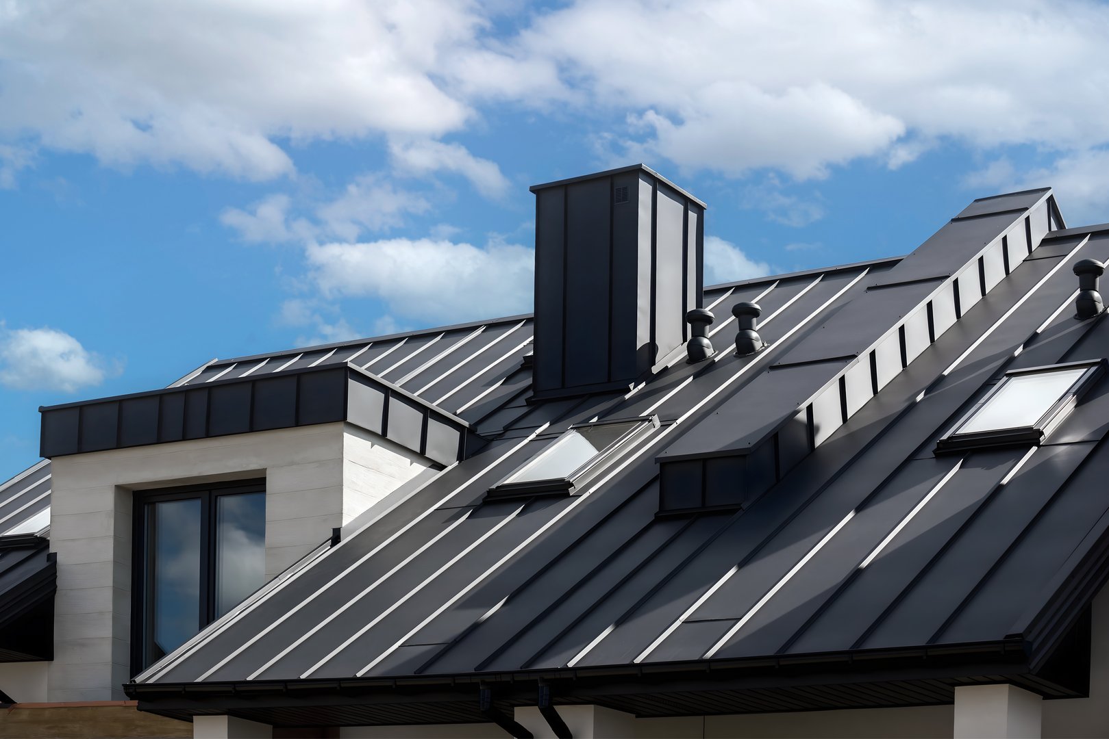 Close-up house retro roof panel with standing seam and fasteners. Classic style black metal panel with rebate joint. Modern galvanized steel roofing sheet with ribs. Falz roofing. Building's covering
