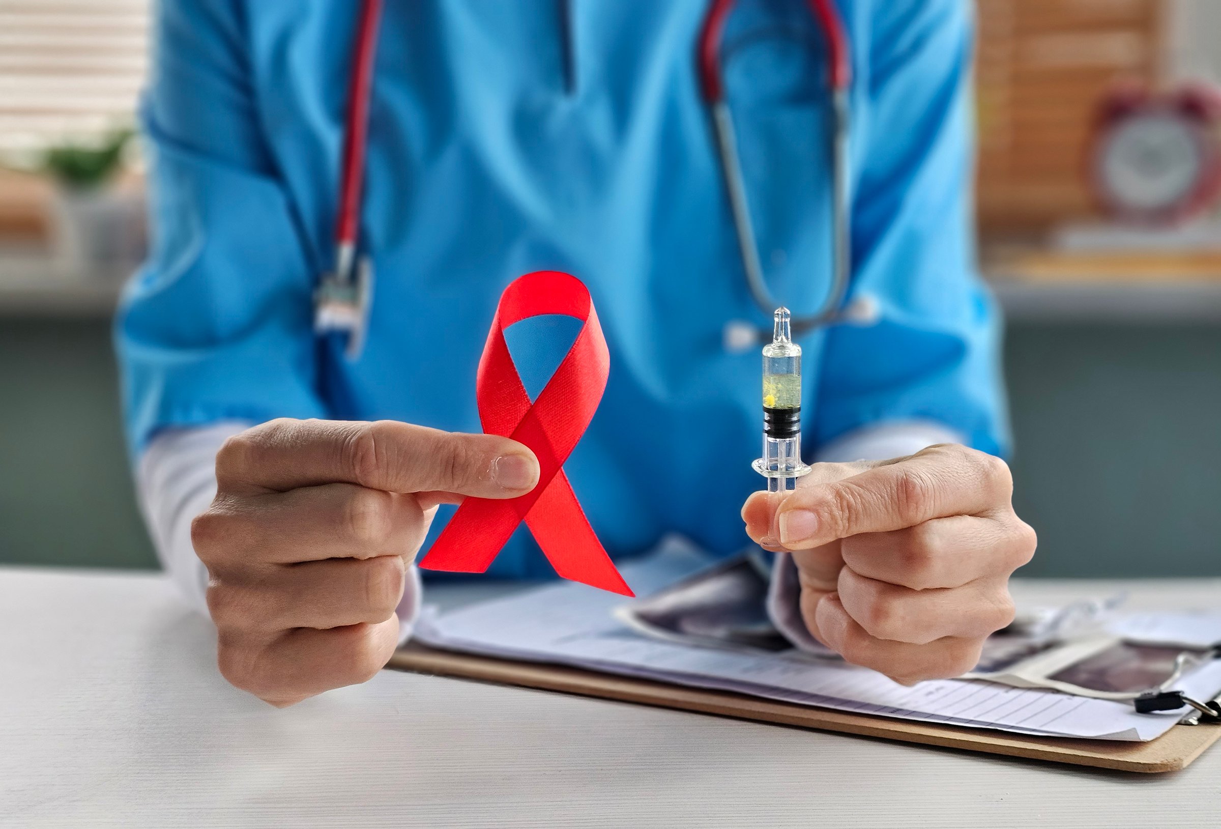 Red bow ribbon symbol of HIV, AIDS, cancer awareness and syringe. Sexual medicine in health care, World AIDS Day