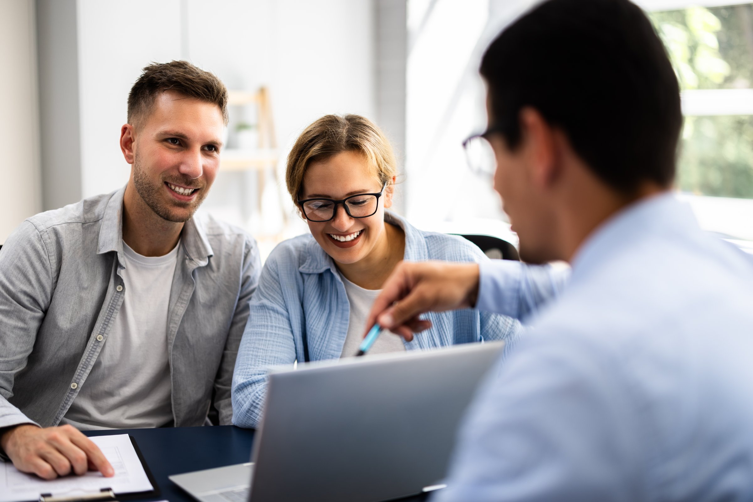 Young Couple Is Meeting With A Financial Planner To Discuss Their Future Investments And Family Finances In An Office.