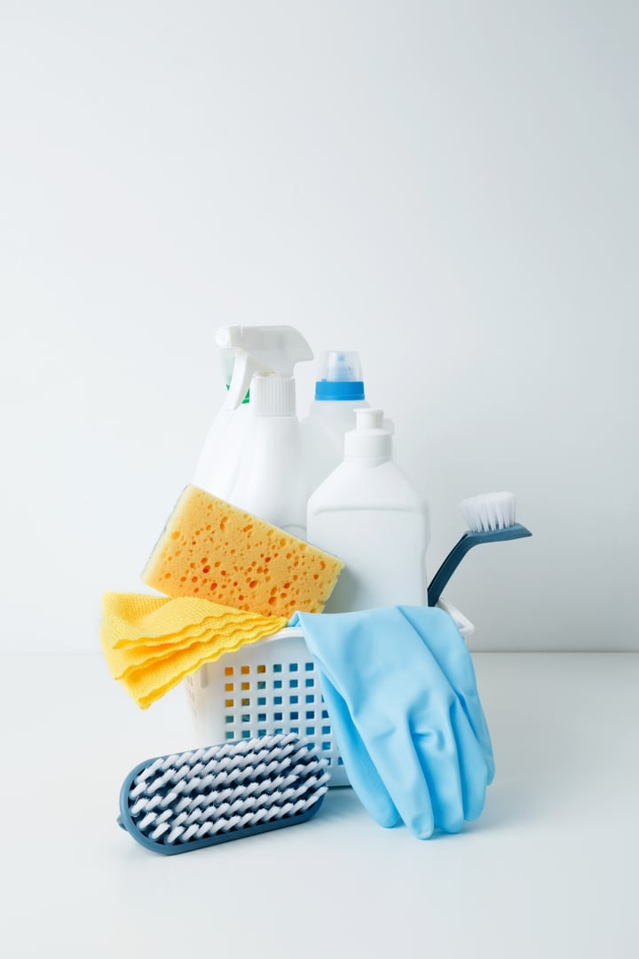 Cleaning supplies in a container, ready for a productive and satisfying spring refresh. Household cleaning and hygiene concept