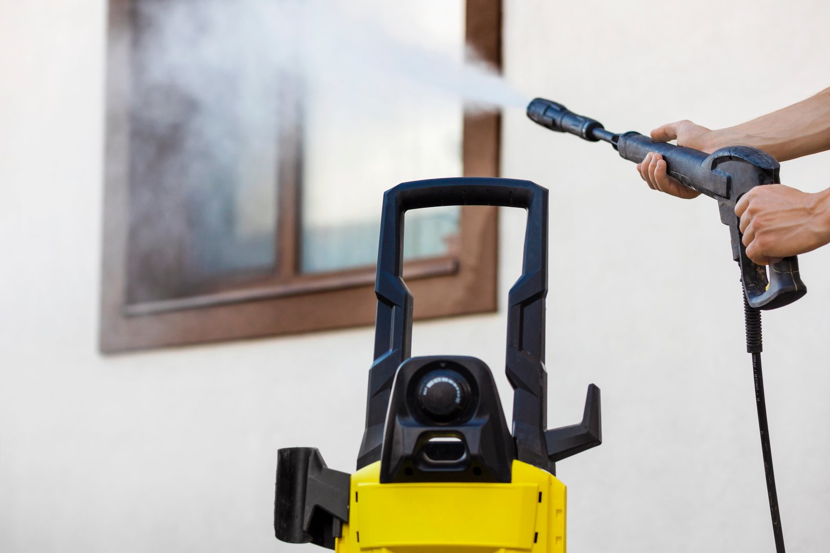 Washing Facade House Cleaning Windows Outside. High Pressure Washer for Cleaning House Facade and Window.