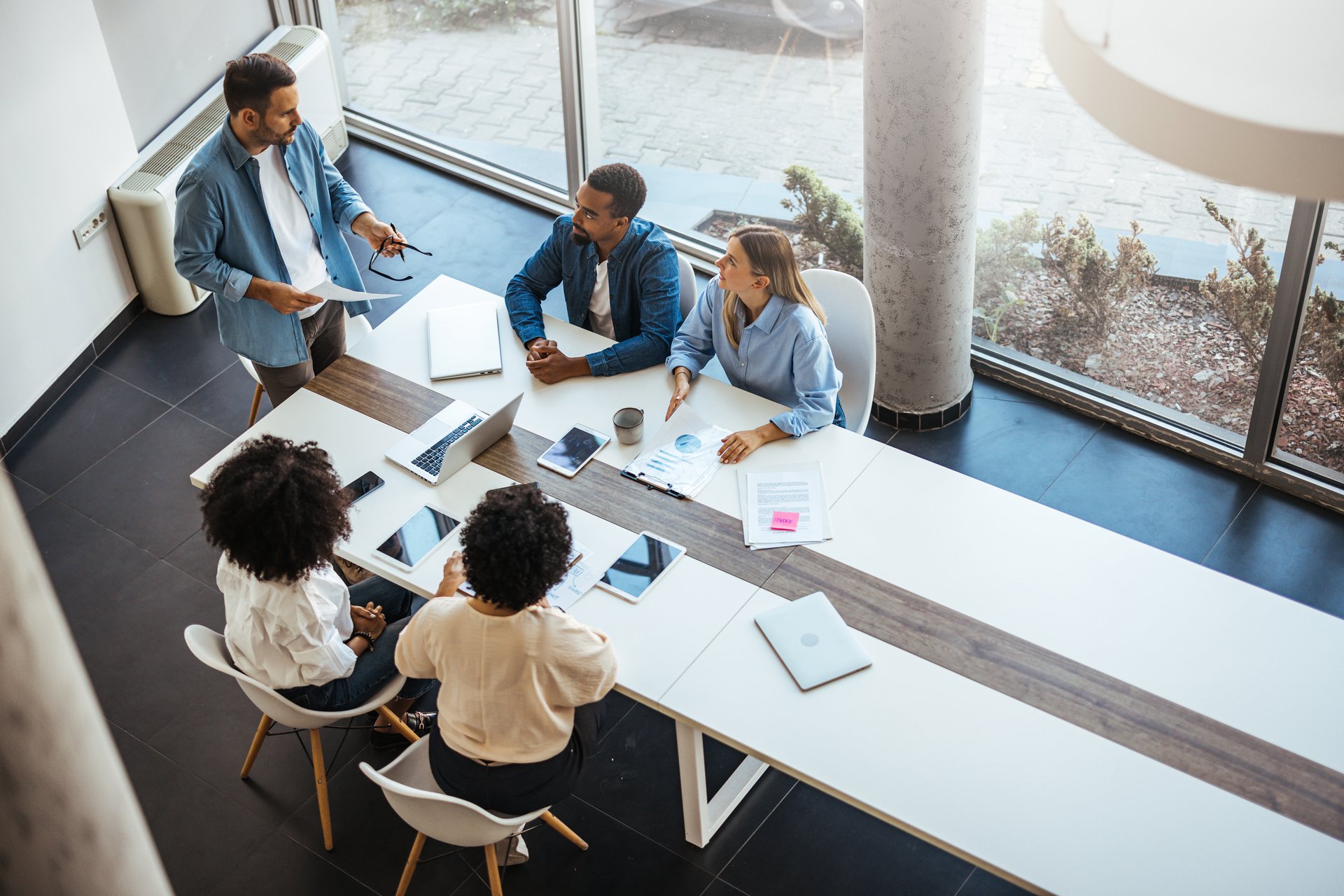 Professional team gathering for a business discussion at a contemporary office space.