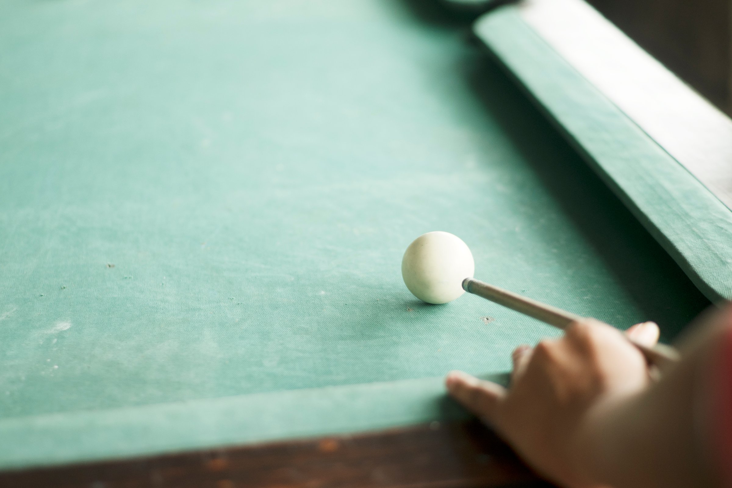 Focused player striking cue ball