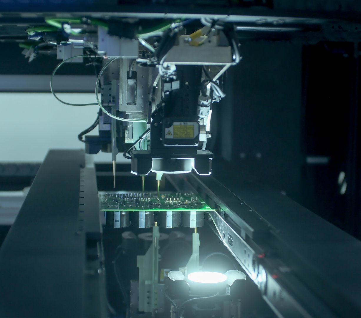 Circuit board moving through assembly line. Electronics and circuit board manufacturing factory. Component installation, CMD. While board moving through assembly line. Automated technology production
