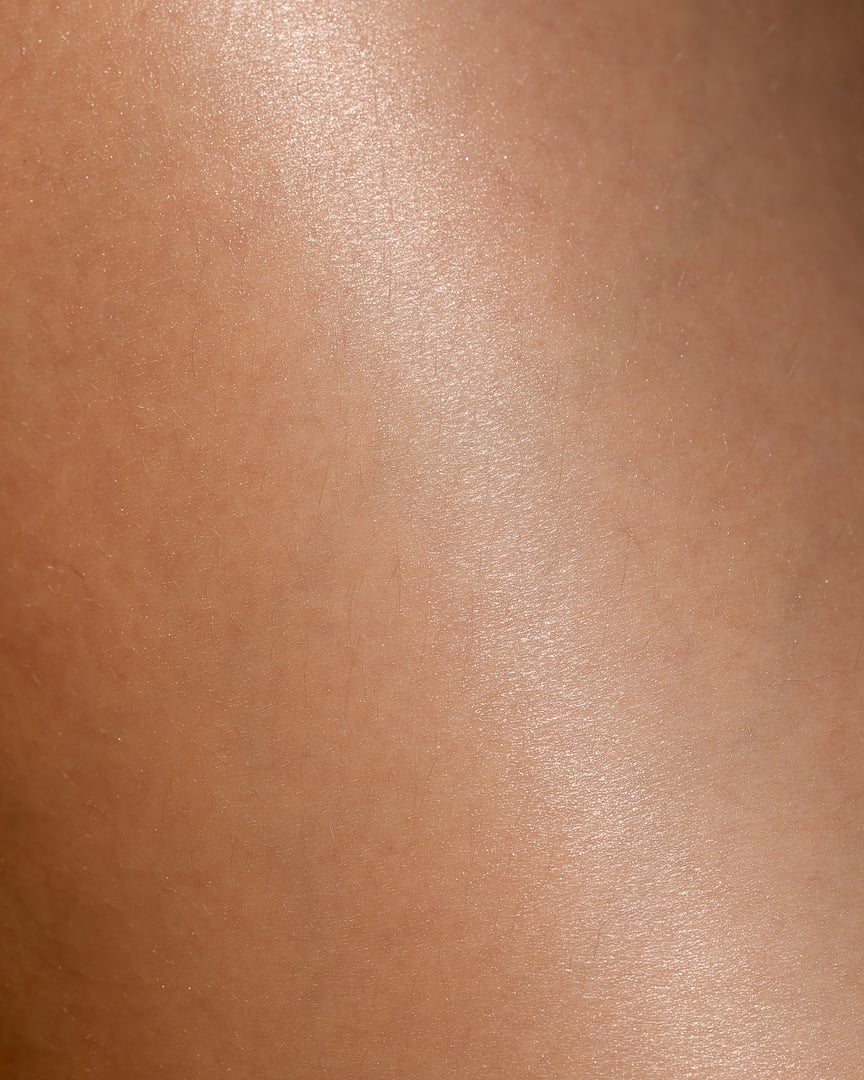 Macro close-up of healthy smooth skin showing natural texture and glow. The detailed shot highlights real skin surface and subtle imperfections, symbolizing natural beauty, wellness, and body care