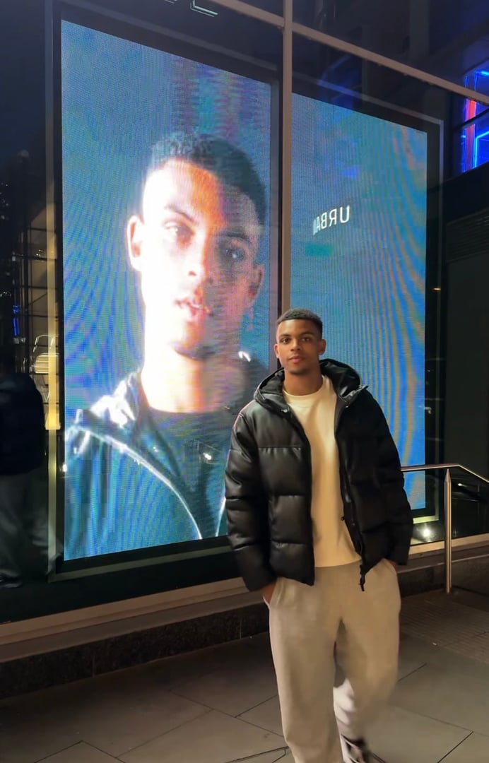 Athletic model showcasing ASICS tracksuit in professional sportswear fashion campaign