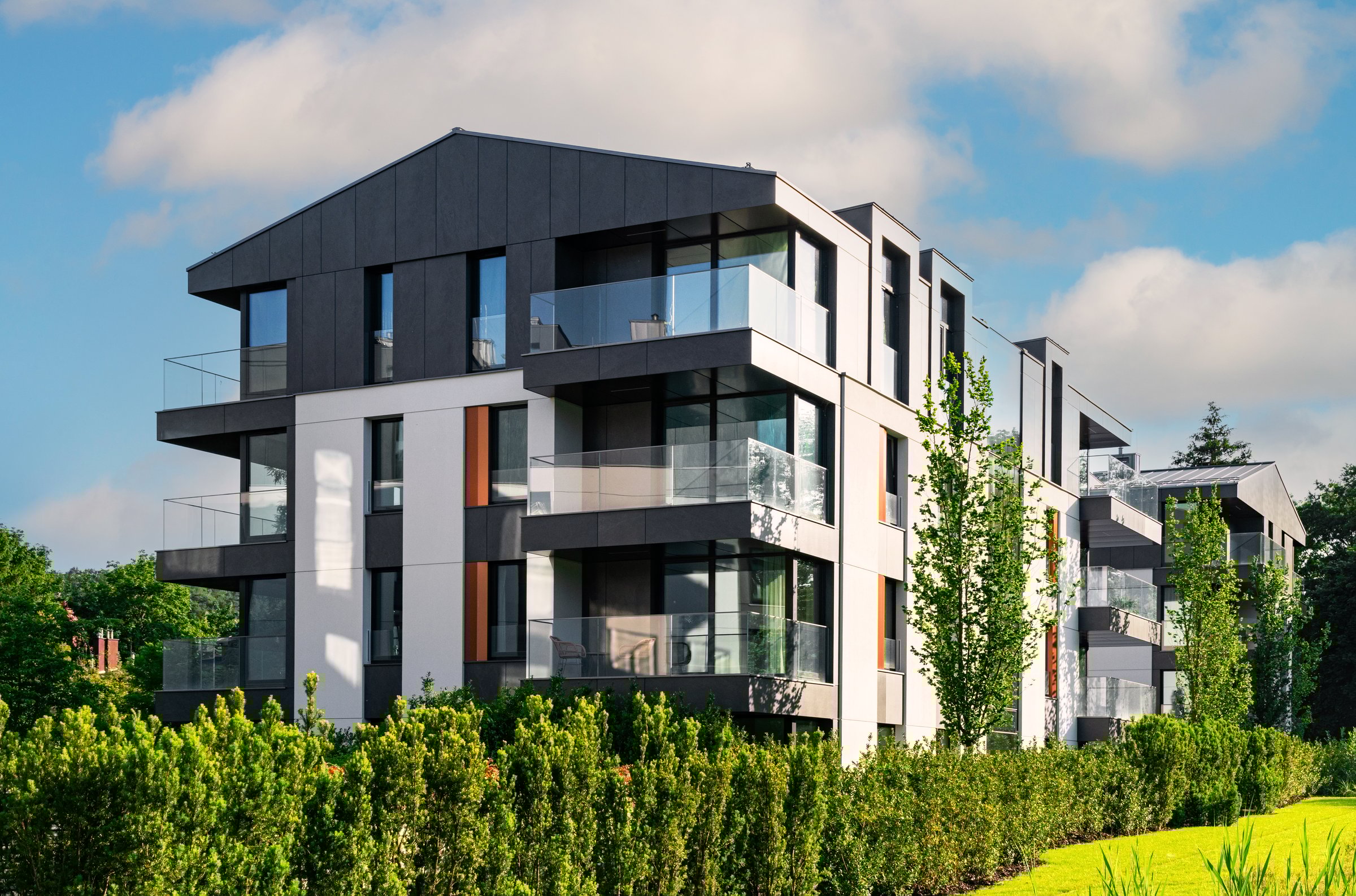 Modern new residential house on the background of the blue sky. House construction industry in Europe