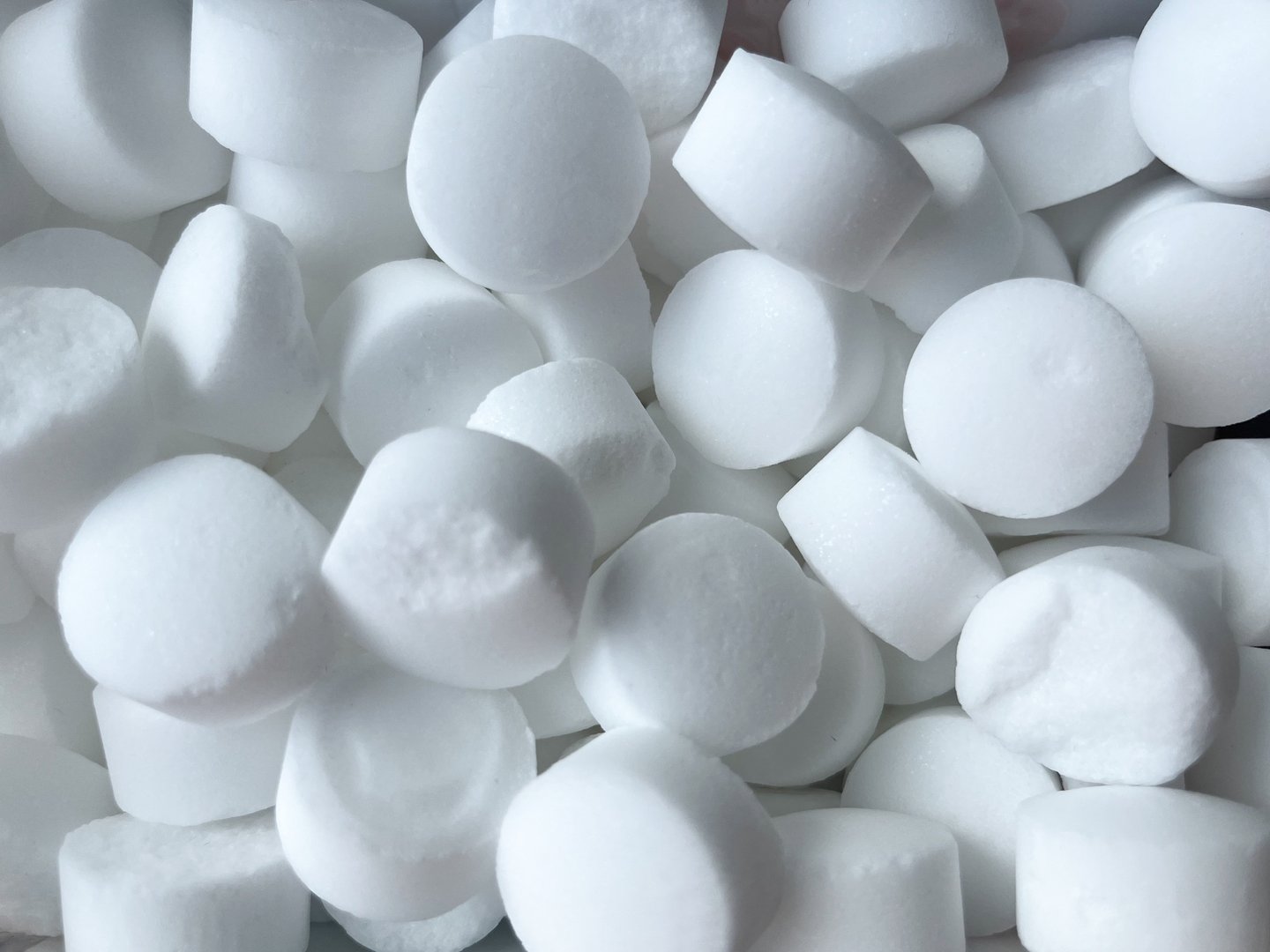 Background of tableted salt for softening water close-up.