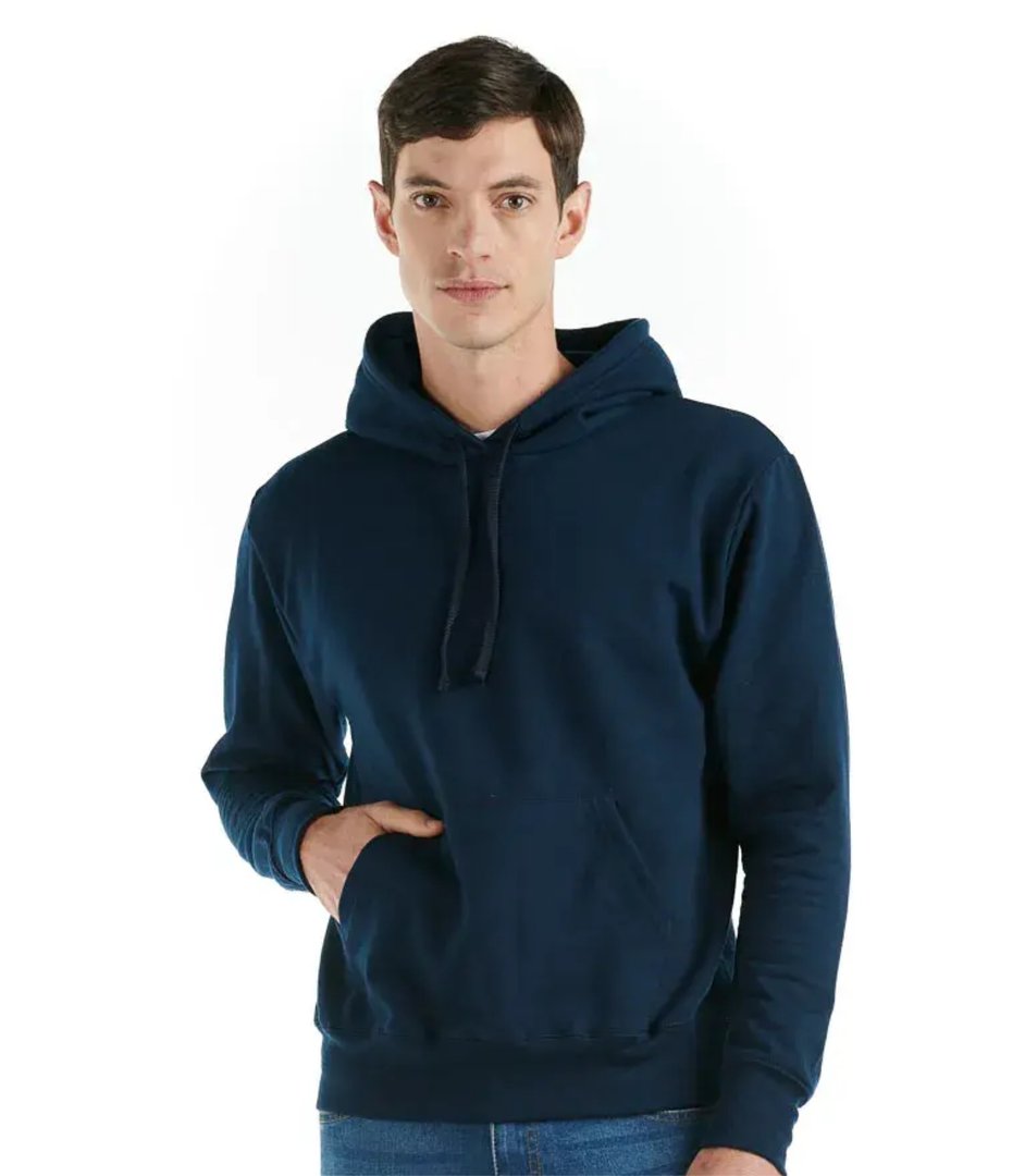 A woman in navy blue scrubs with blonde hair smiles at the camera, standing against a plain white background.