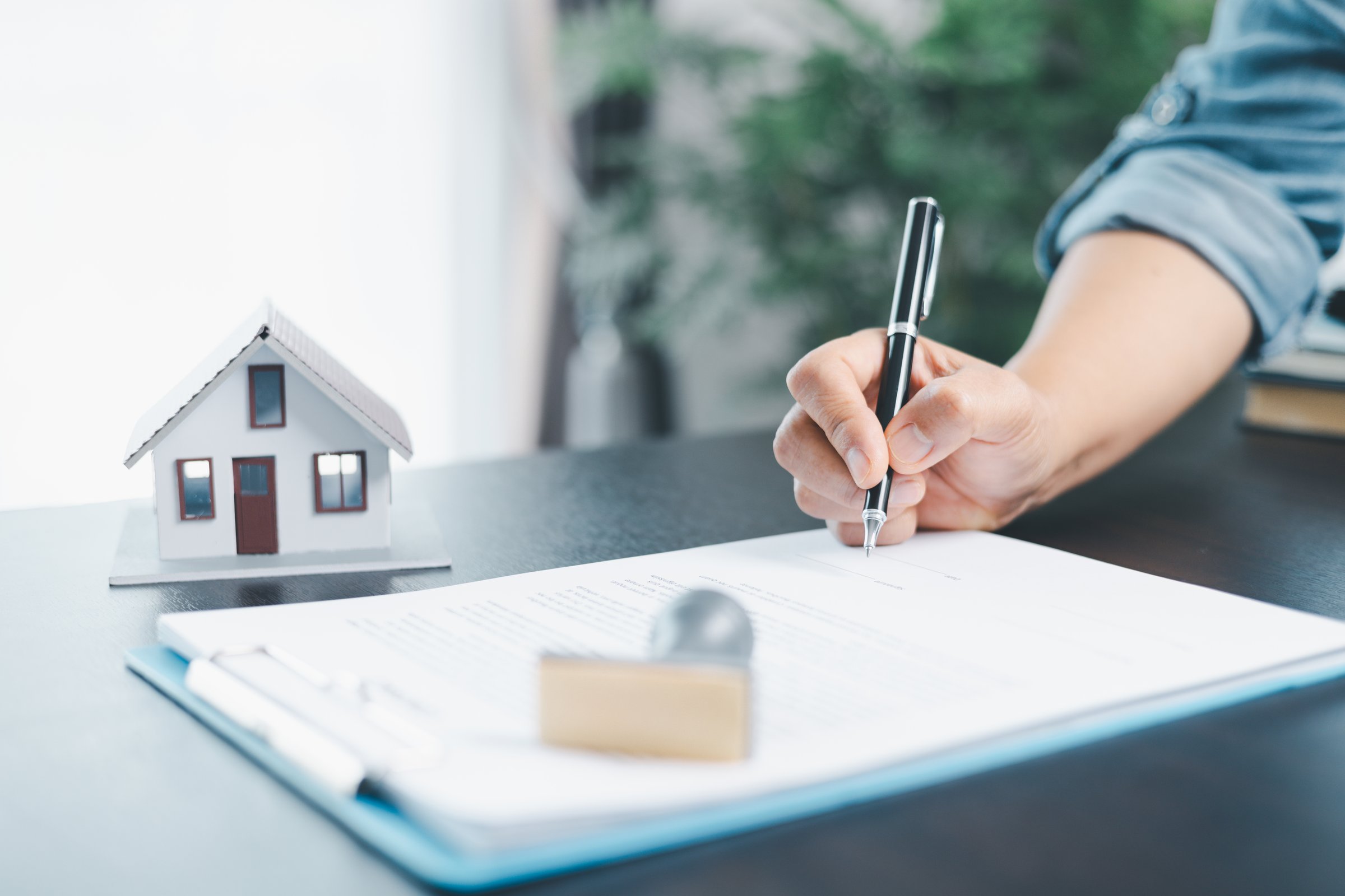 Businesswoman hand stamp approve on financial business approval document paper. Man hand accept permit contract agreement. Broker manager sign contract bank guarantee approved stamp application form