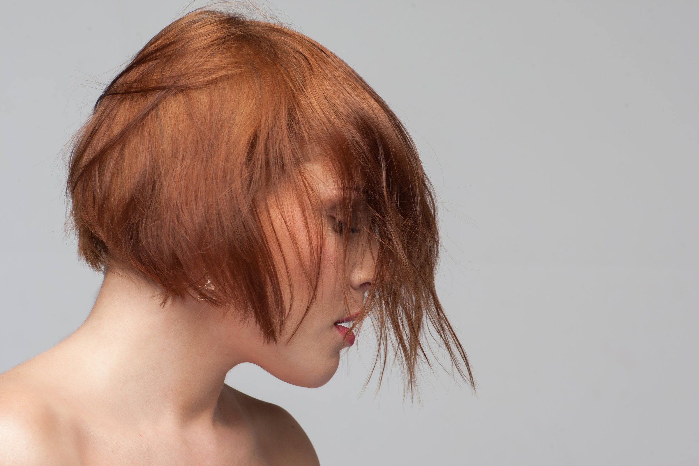 Offended female. Creative hairstyle advertising. Modern fashion look, relationships problem. Woman portrait closeup, young girl on grey background with free space