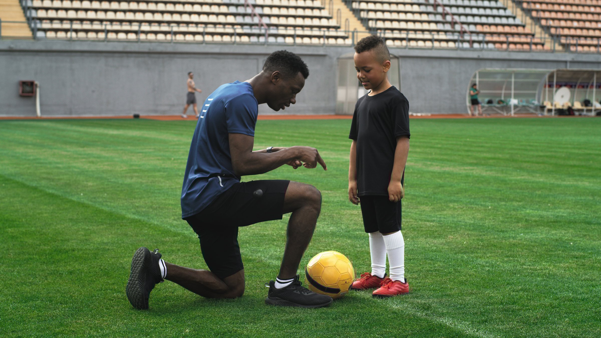 Zoom in view of coach explaining game strategy during soccer training