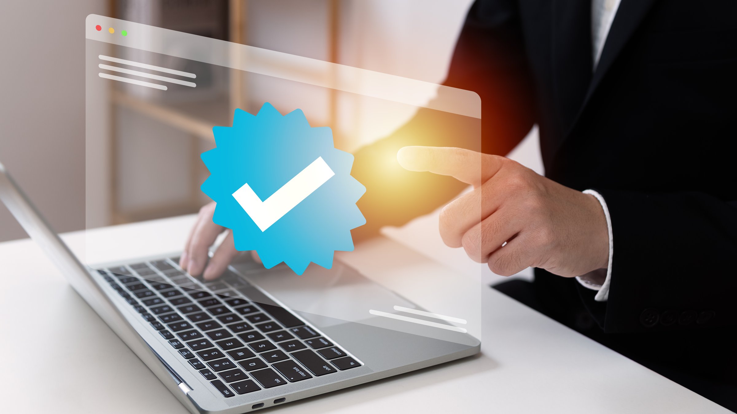 Businessman using laptop with verification account blue tick checkmark concept, verification account on social media platform, subscription status, eliminate bots, spam.