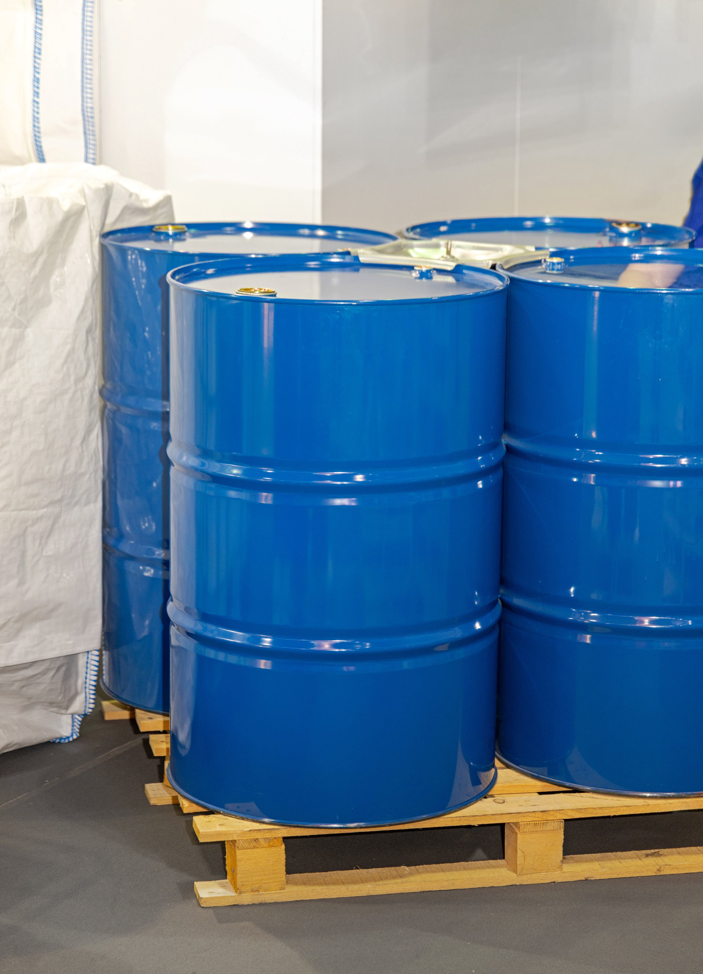 Blue Metal Barrels Drums Liquid Storage at Pallet in Industrial Warehouse