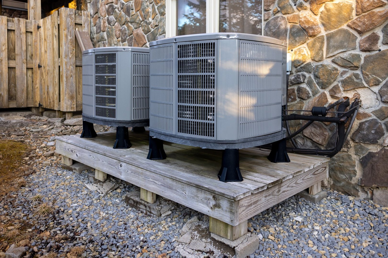 Outdoor dual zone heat pumps next to house