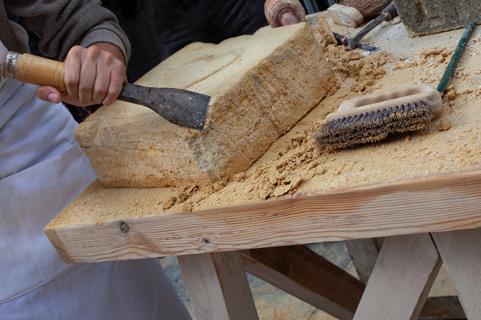 Stonemason working on a wooden table