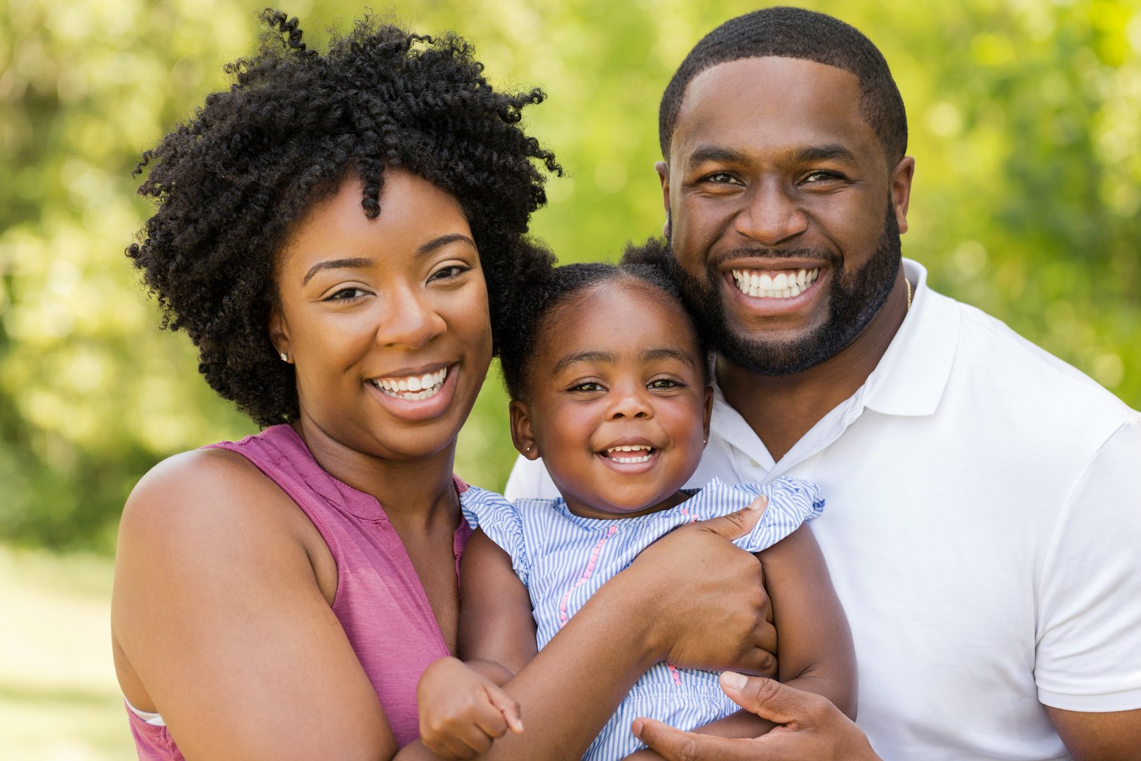 African American family laughing and smiling.