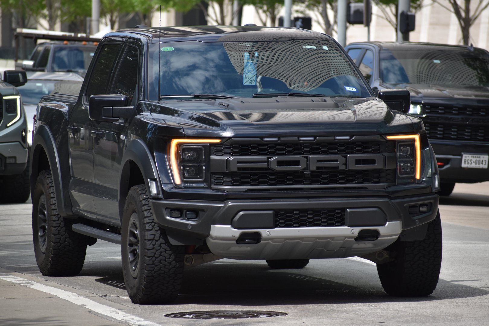 Houston, TX USA - A portrait of a black Ford F-150 pick-up truck cruising in a downtown district