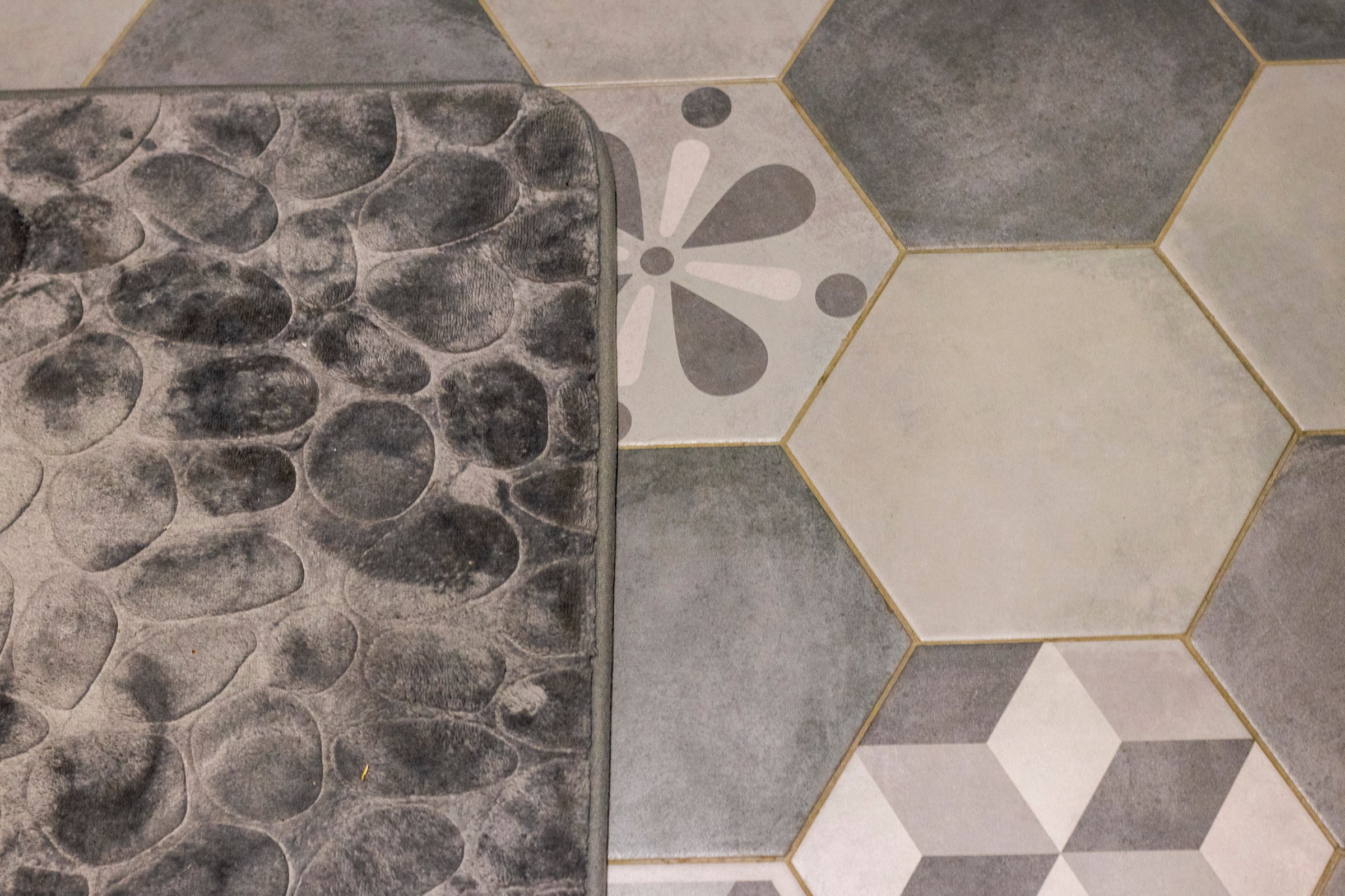 Shot of the mat on the tile floor of the bathroom