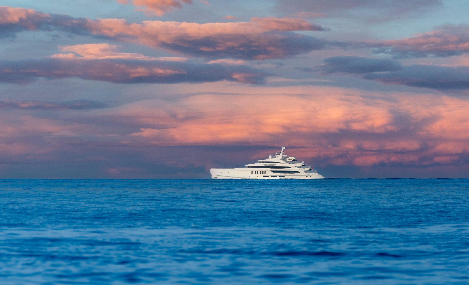 A luxurious yacht sails across the calm ocean under a stunning, colorful sunset sky, capturing a moment of tranquility and elegance