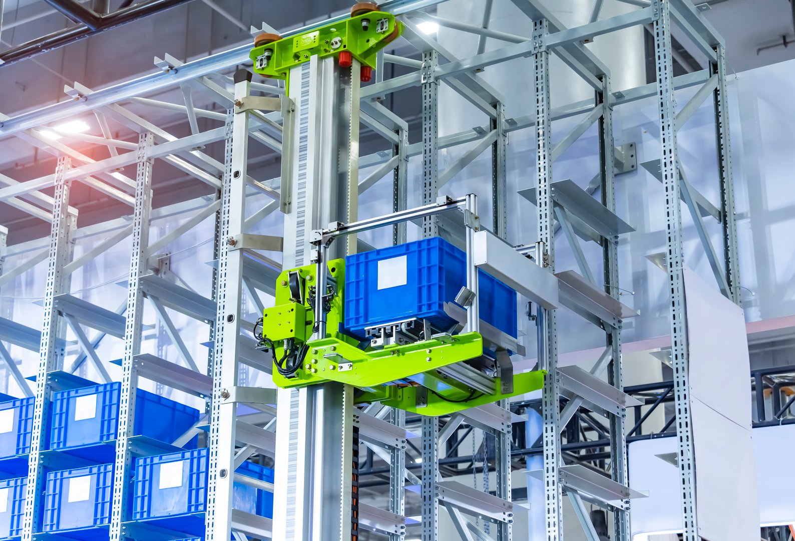 Plastic boxes in cells of automated warehouse metal construction shelving