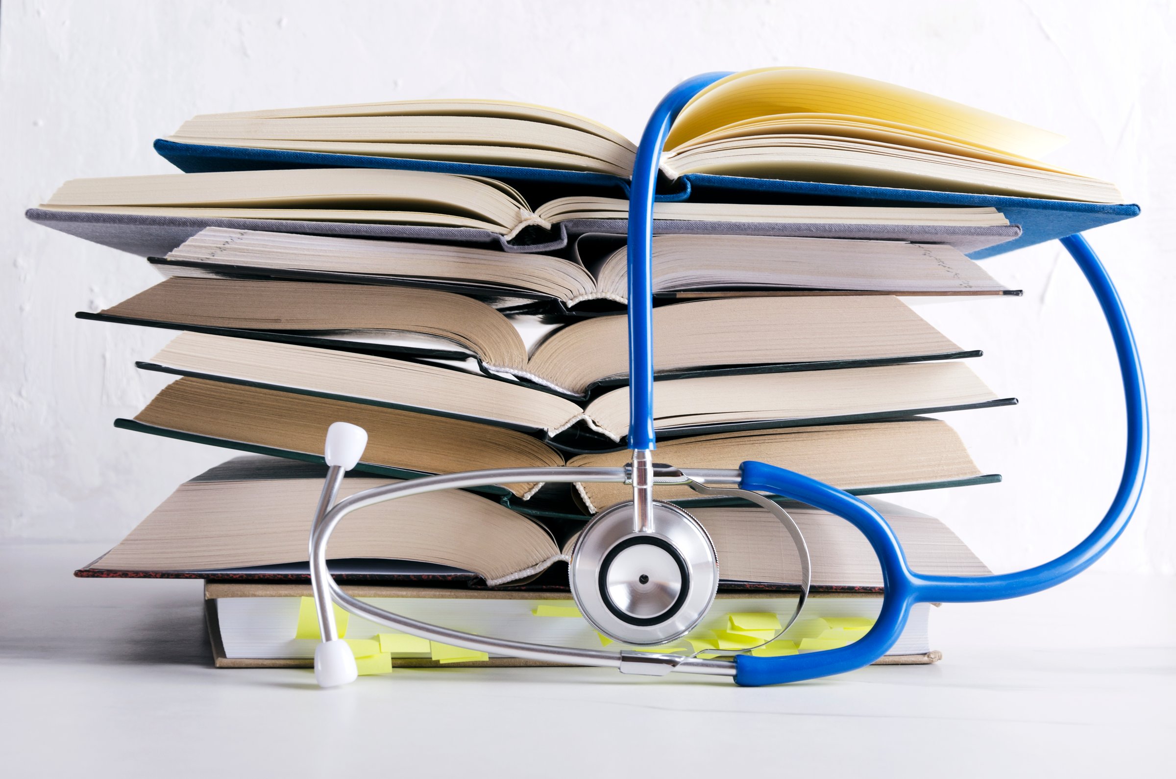 Open medical books, stethascope. Process of medical learning