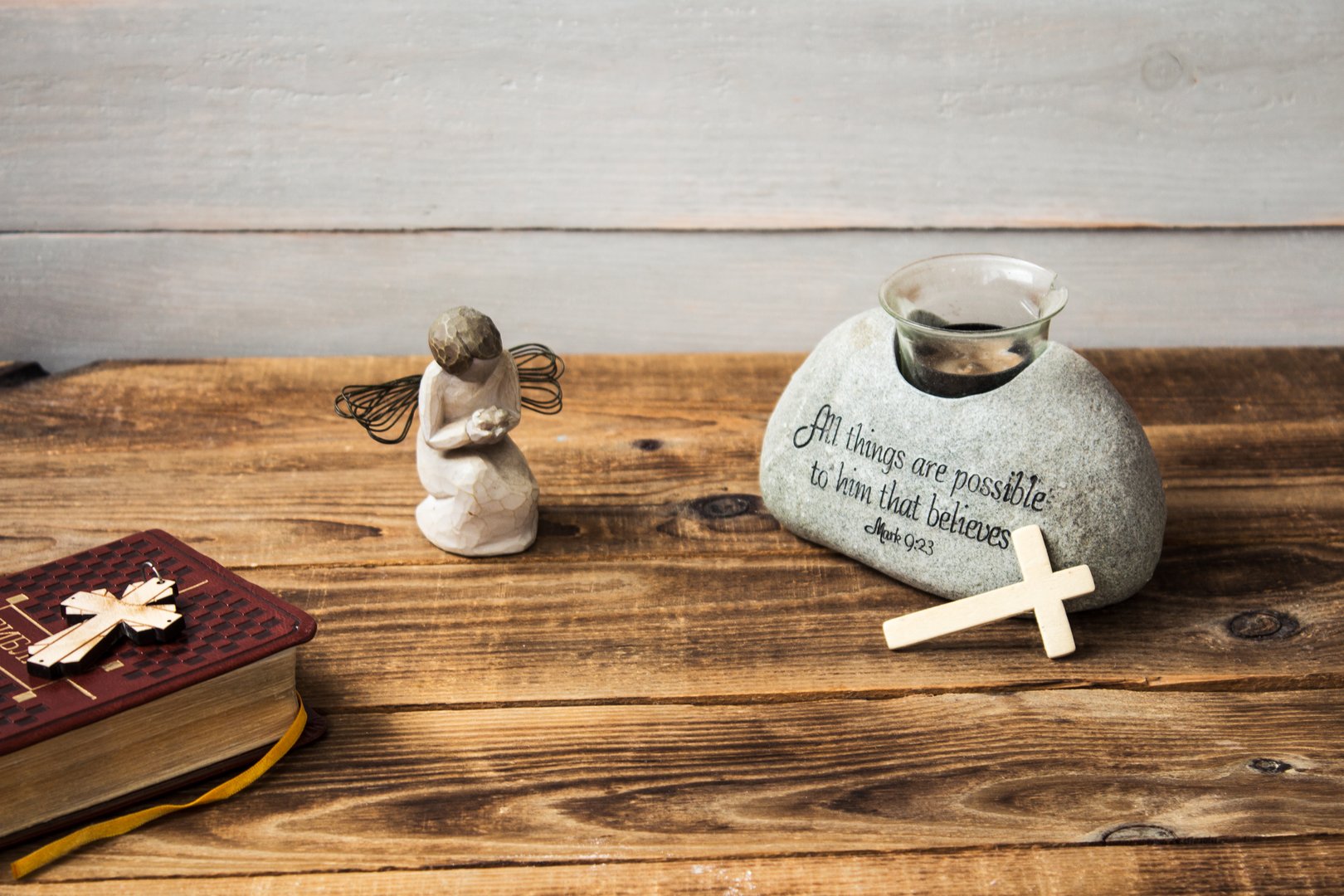 a angel bible and cross on wooden background