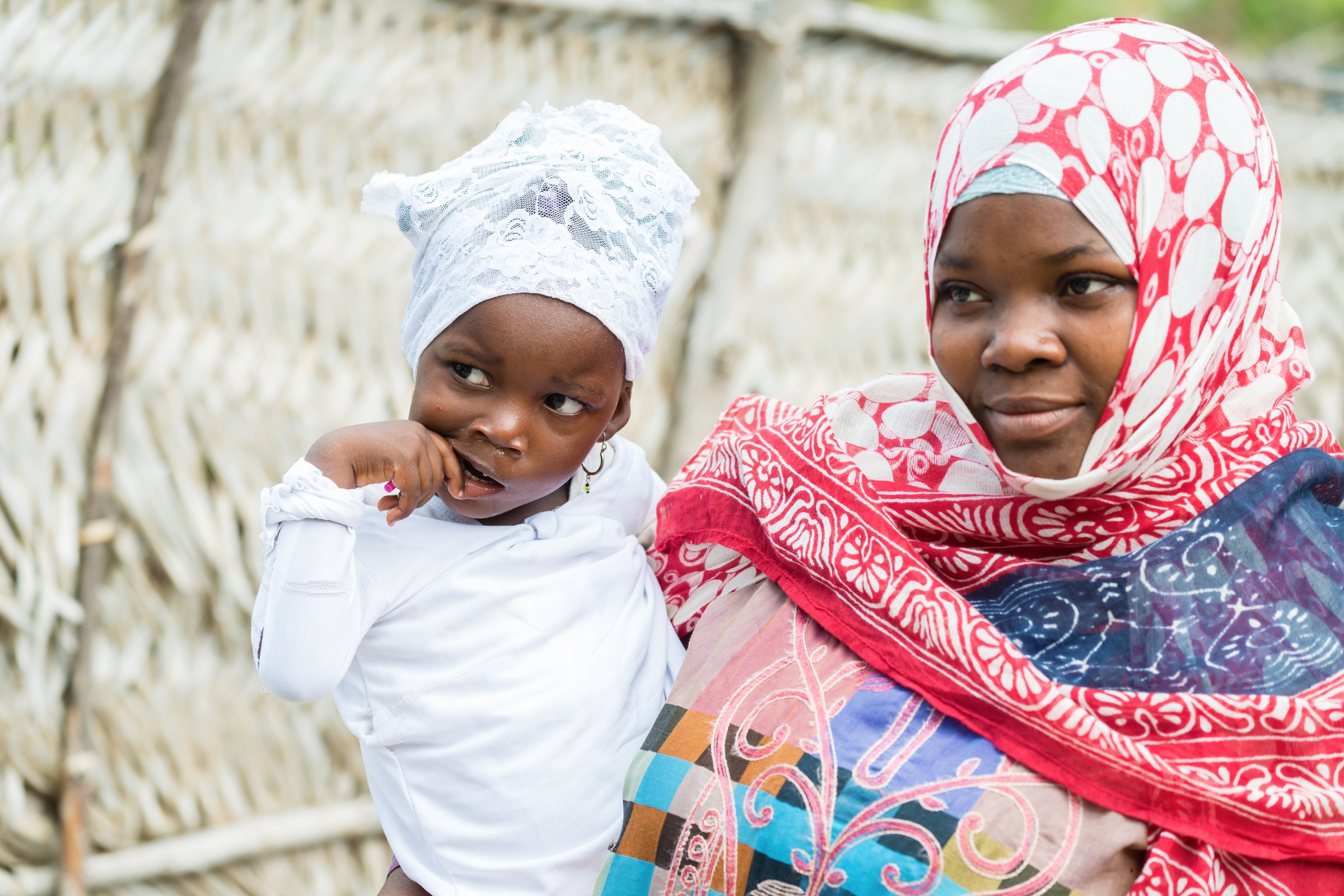 African black woman holding her daughter outdoors