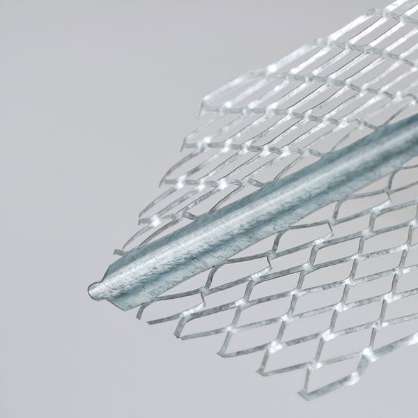 Close-up of a metal mesh corner bead with a pointed tip used in construction for reinforcing corners.