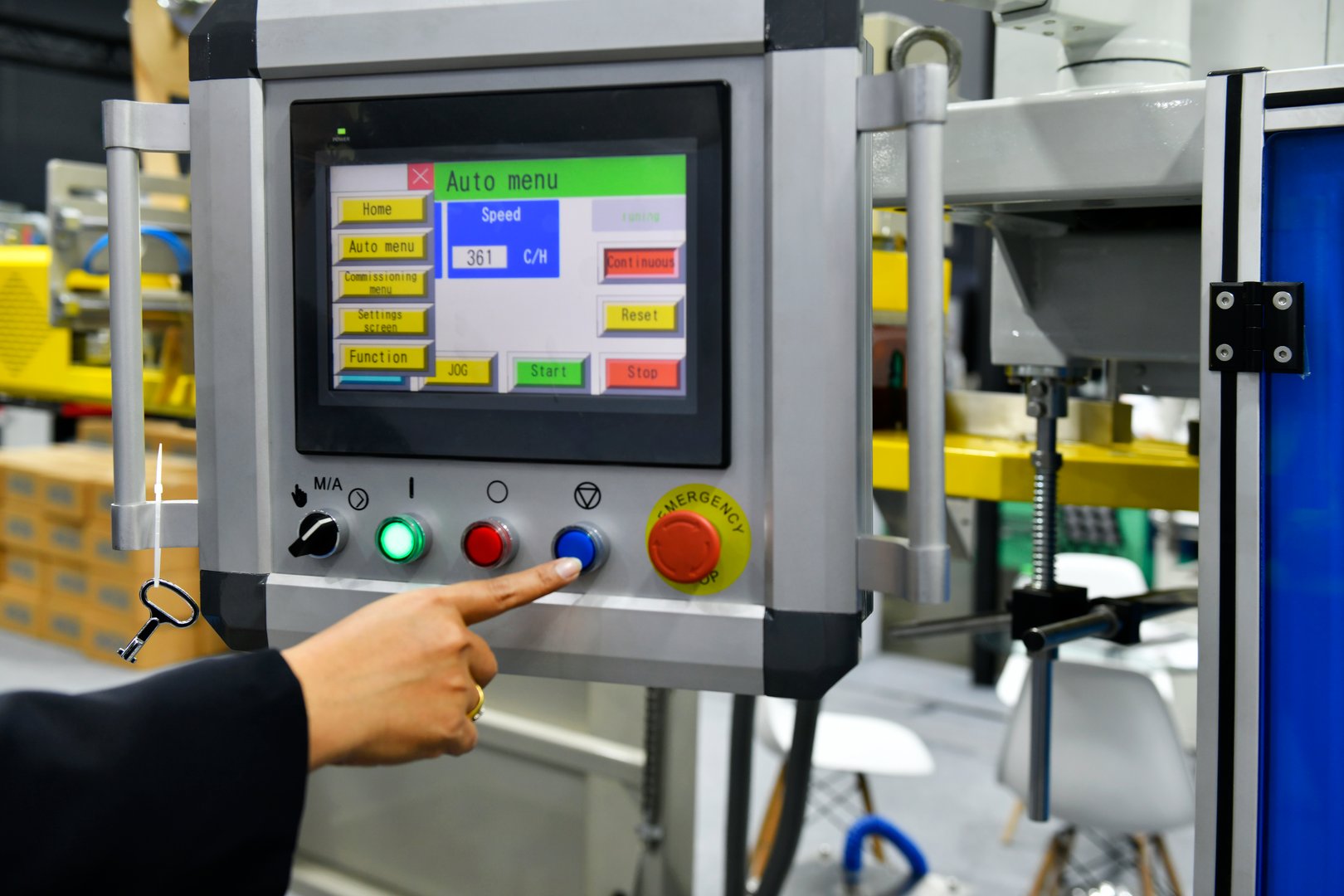 Machine operator hand turns on control panel of industrial machine. technician push button on control panel
