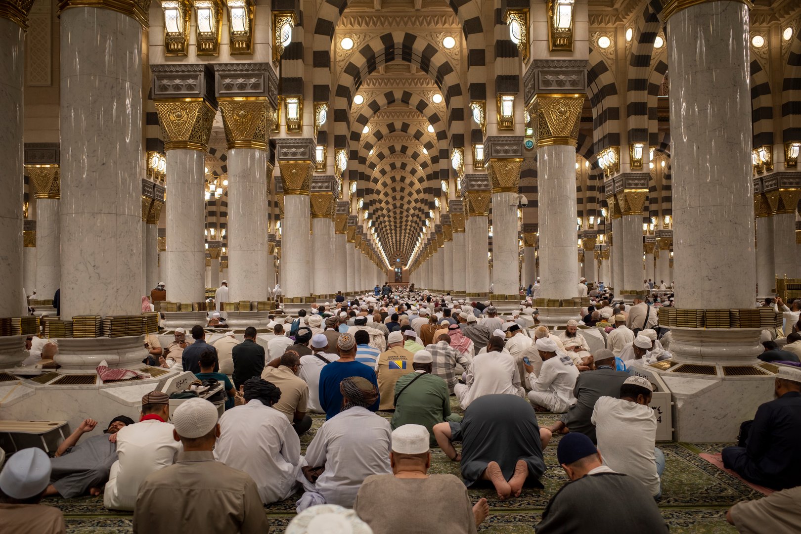 Hajj pilgrims praying in the Nabawi Mosque, the Prophet Mosque in the city of Medina, Saudi Arabia.