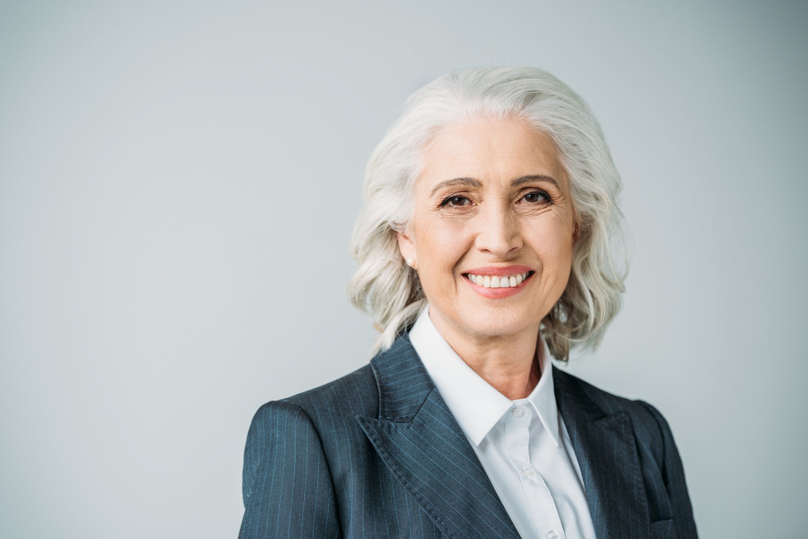 Portrait of smiling senior businesswoman in suit