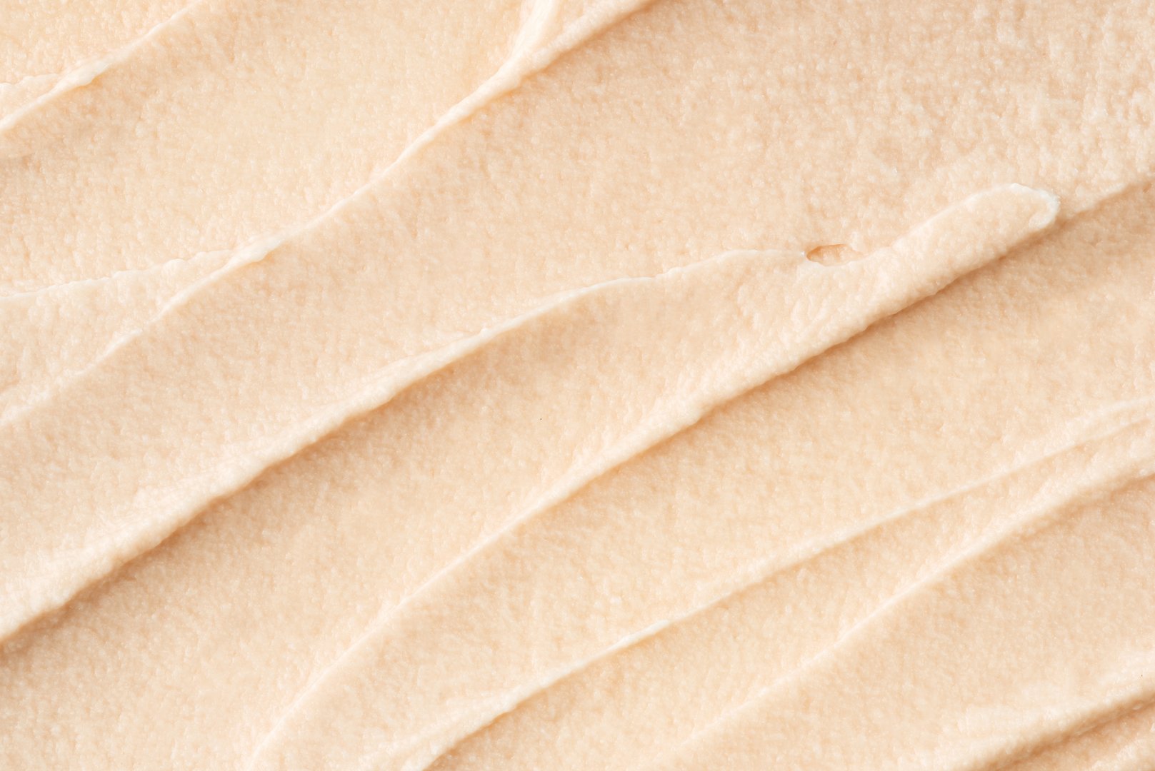 The texture of a beige cream or scrub