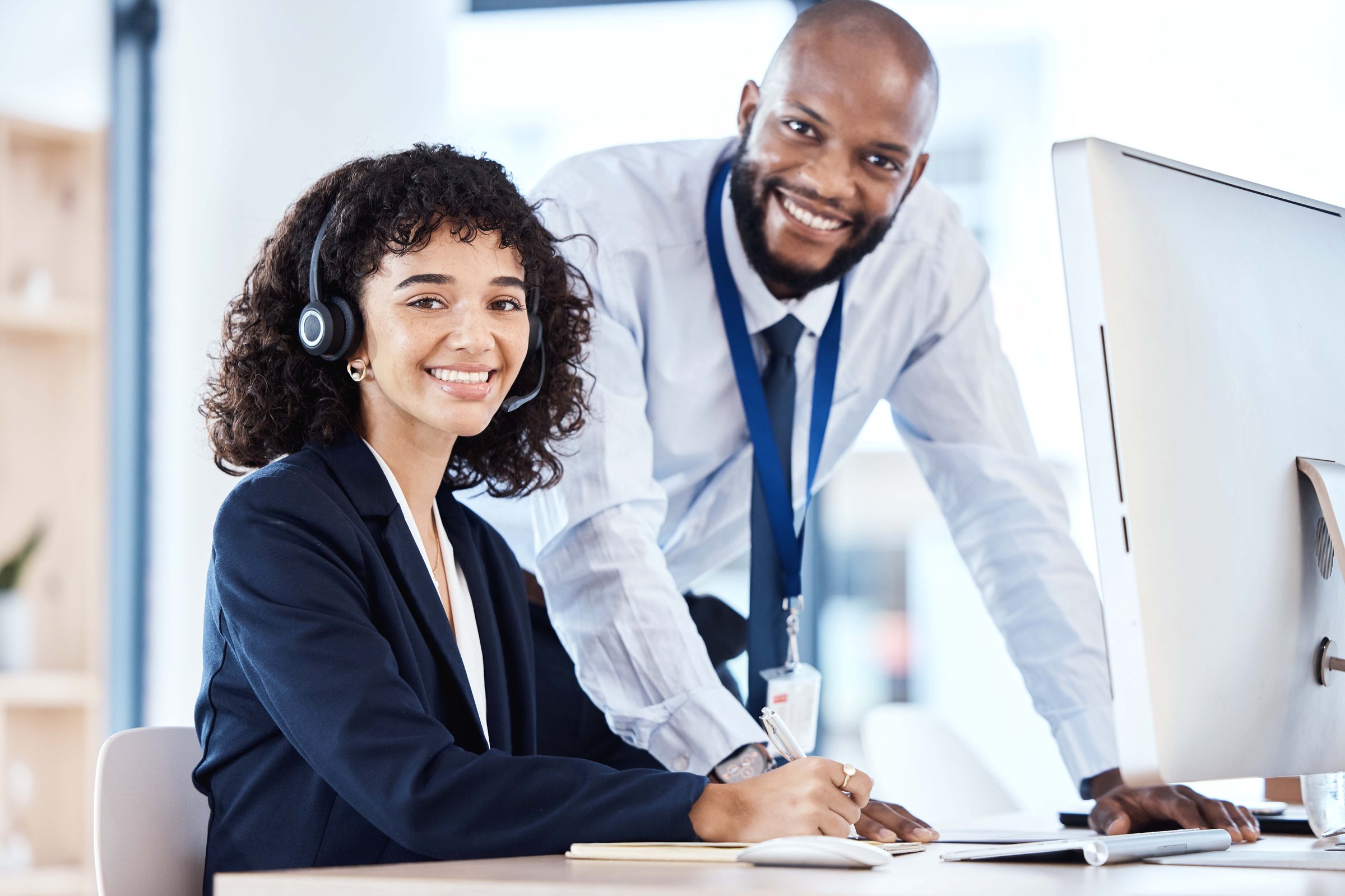 Call center, customer service and portrait of a manager with a consultant helping with a consultation online. Happy, smile and professional telemarketing agents working on crm strategy in the office.