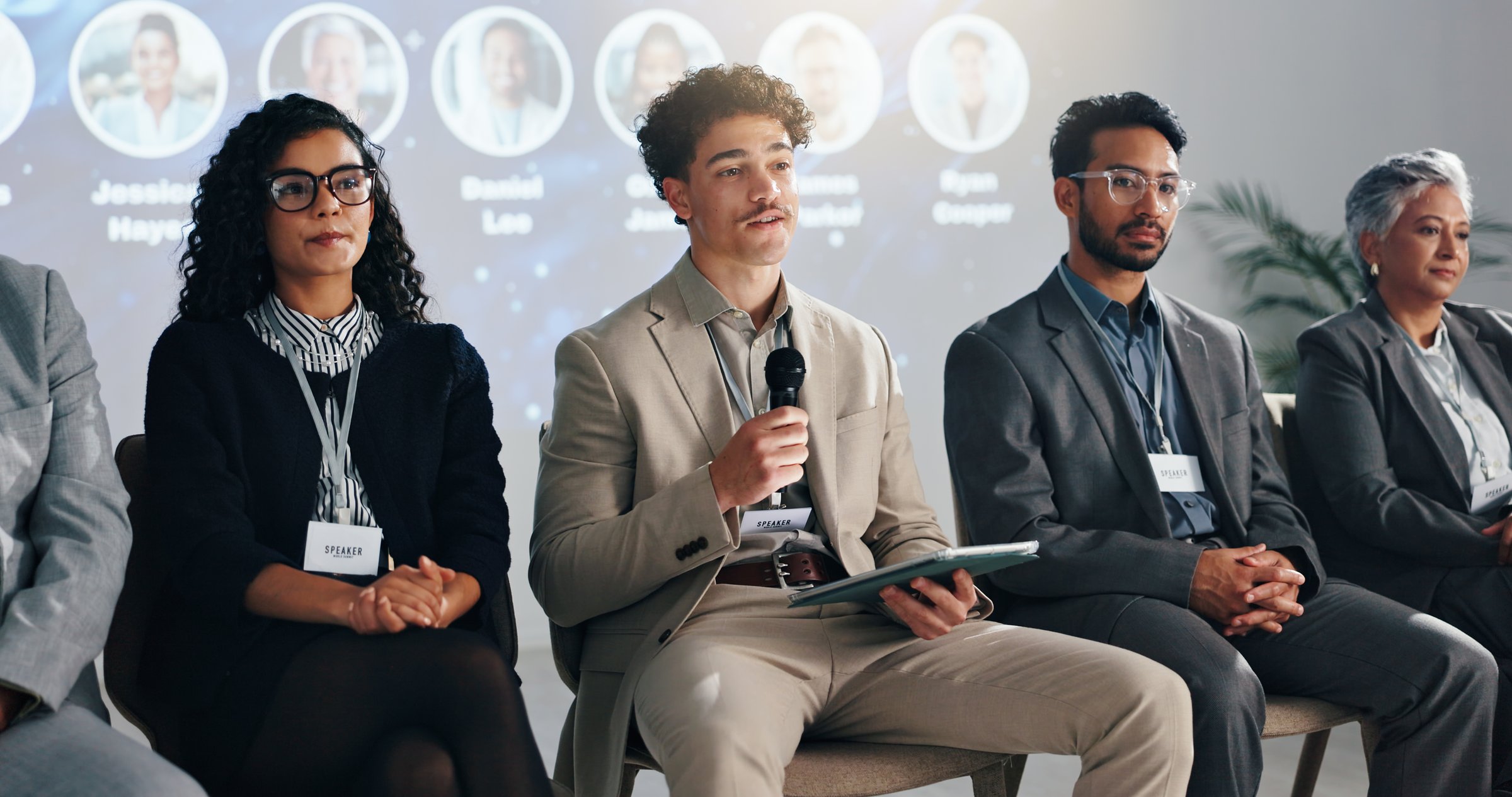 Conference, tablet and panel of people on a stage for discussion, seminar faq and presentation. Business summit, innovation expo and men with women with tech for tradeshow, event and convention