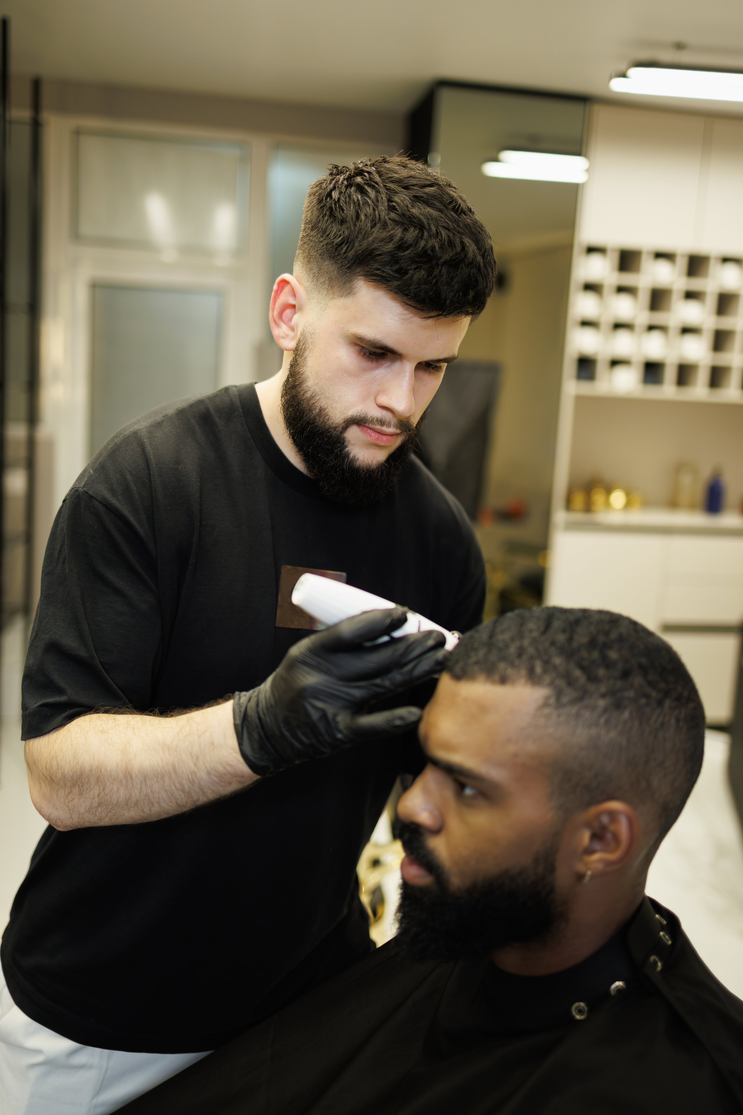 Barber giving haircut to African American customer
