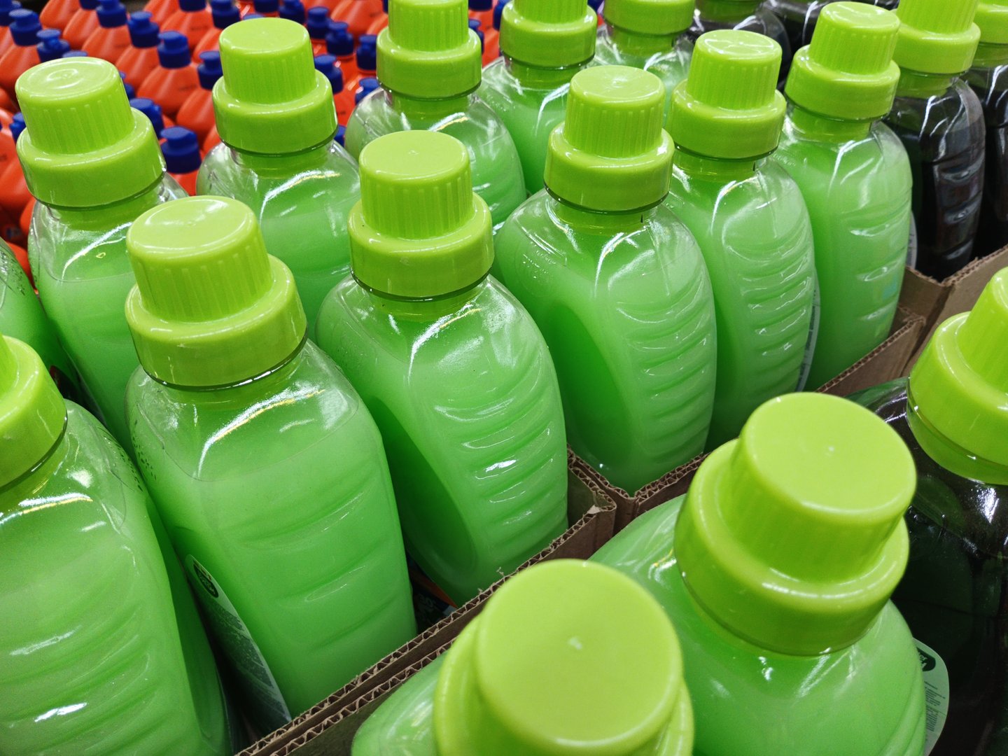 multicolored plastic bottles with household chemicals on the shelves in the store