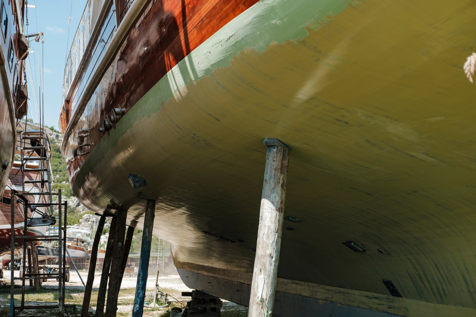 wooden gulet boat hull in dry dock maitenance ready for paint, maintenance of yacht